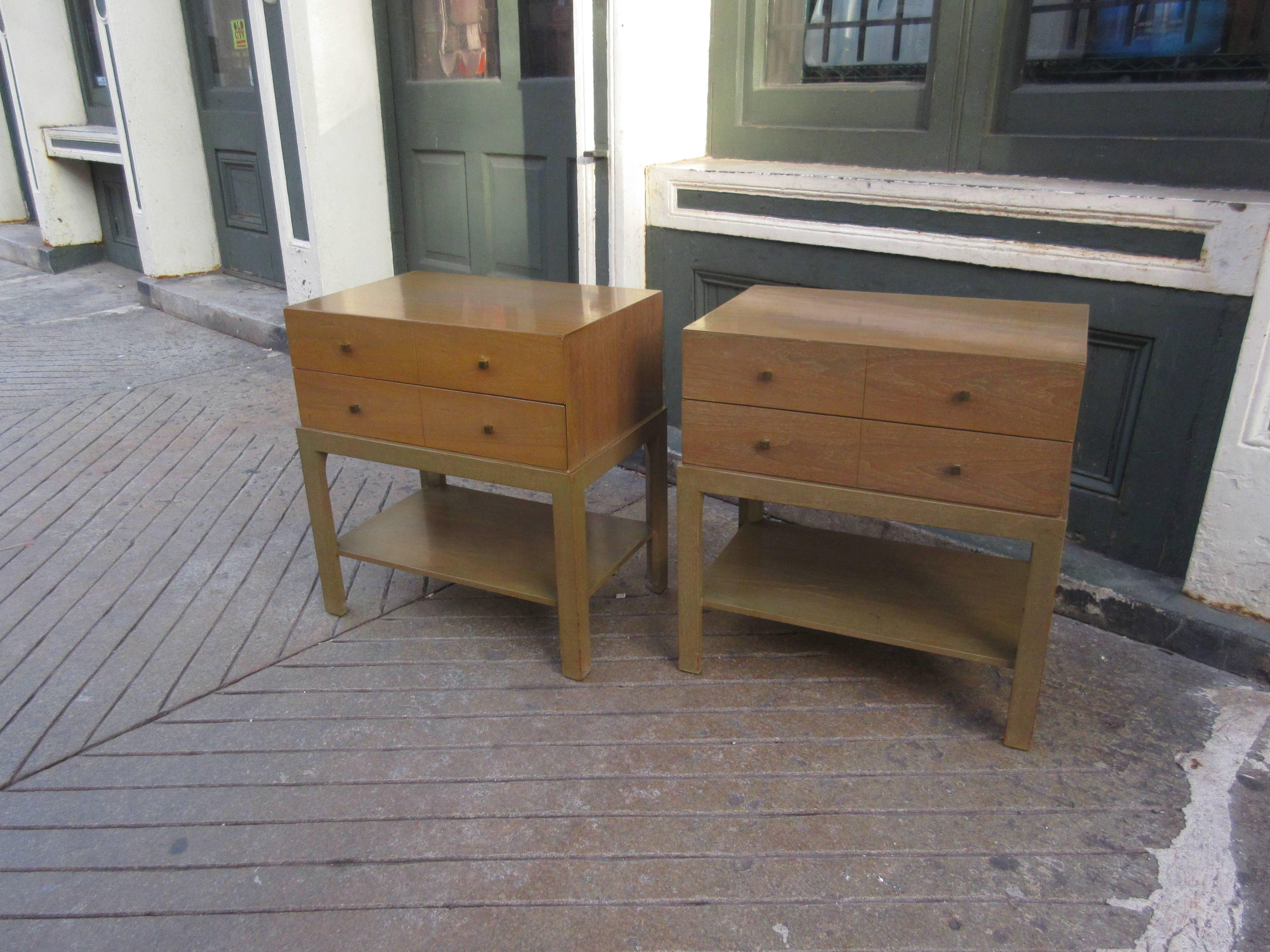 Matching nightstands that have the appearance of boxes sitting on raised stands with bottom shelf. Two drawers, with four small brass knobs. Retains original finish in better than average condition. Decal labels in bottom of drawers.