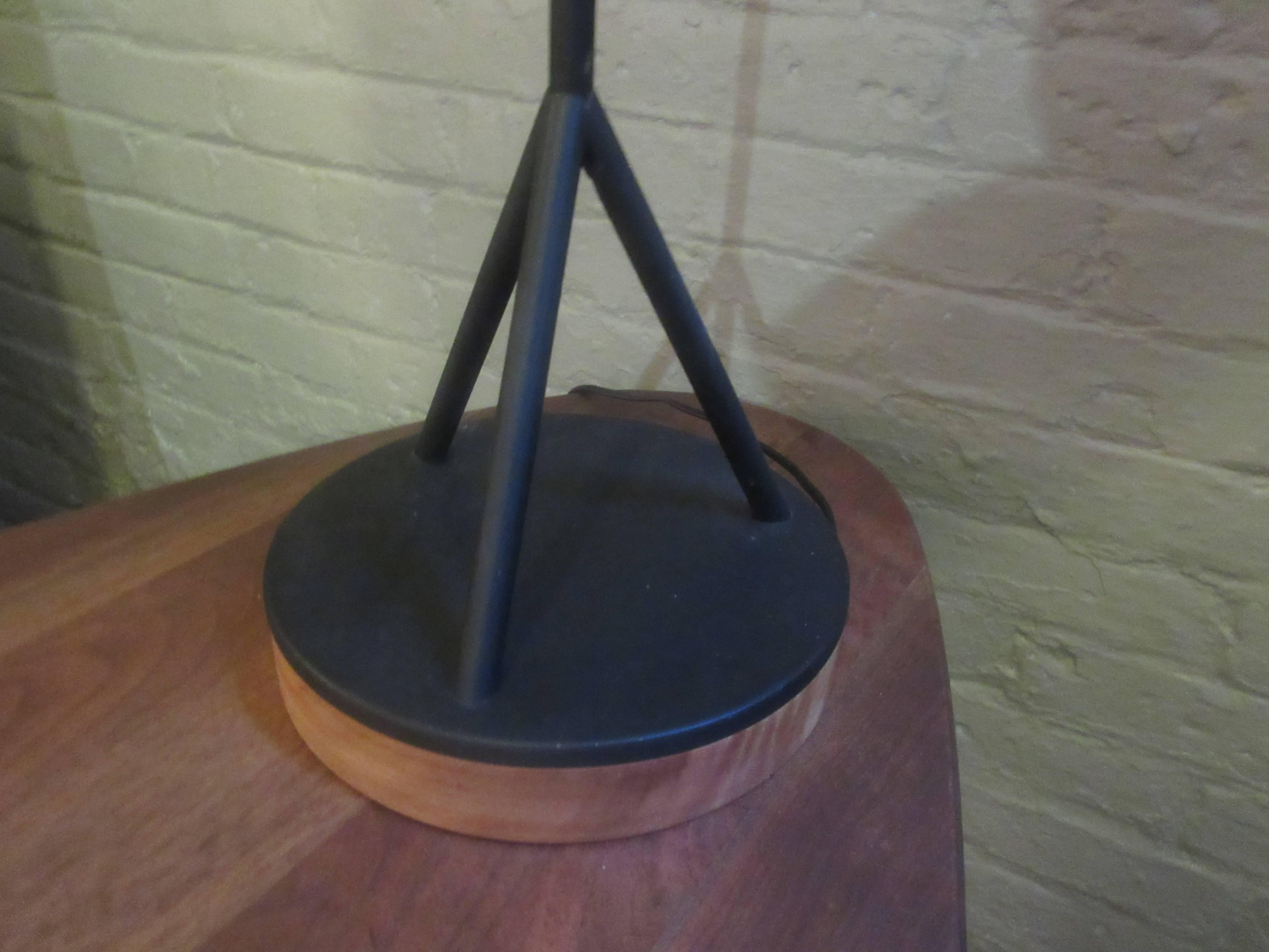 Tubular steel lamp on wooden base with original fiberglass china cap shade.