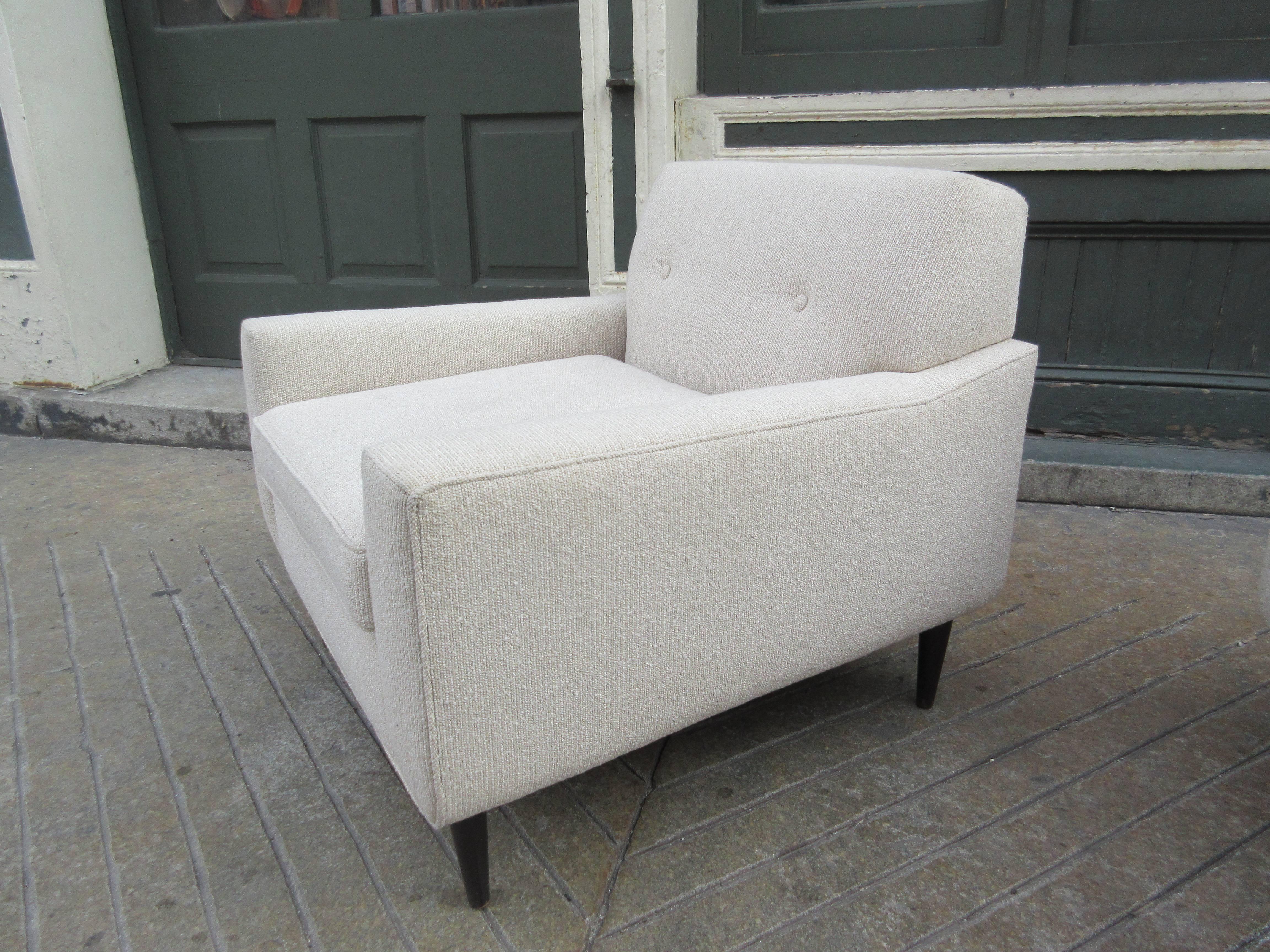 Newly upholstered pair of lounge chairs. Nice side profile gives these a unique look! Walnut legs with a nubby cream or oatmeal fabric.