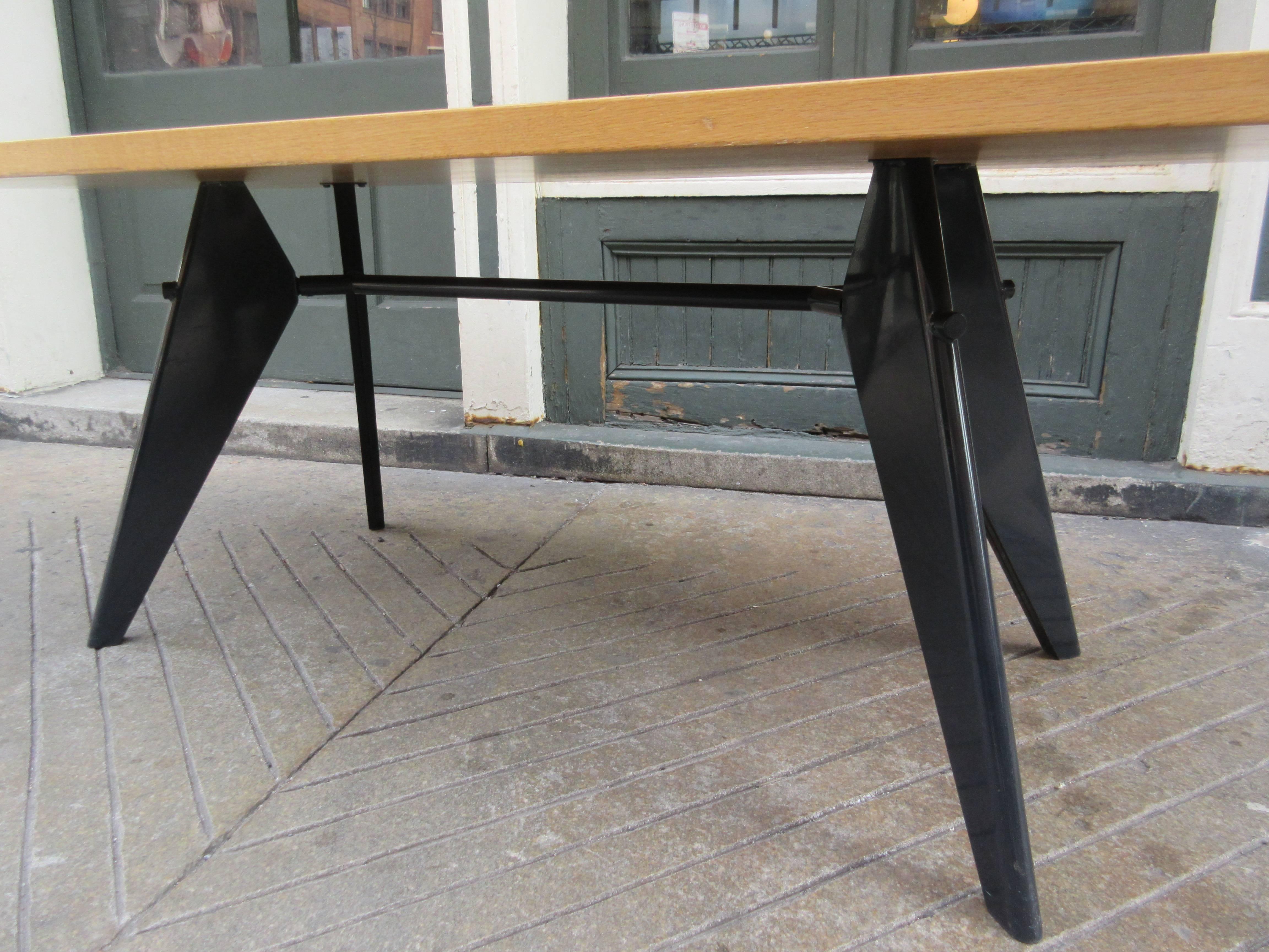 10 year old Vitra produced prouve em dining table. Oak finished top with black metal base. Original design is from the Project Maison Tropicale, circa 1950.