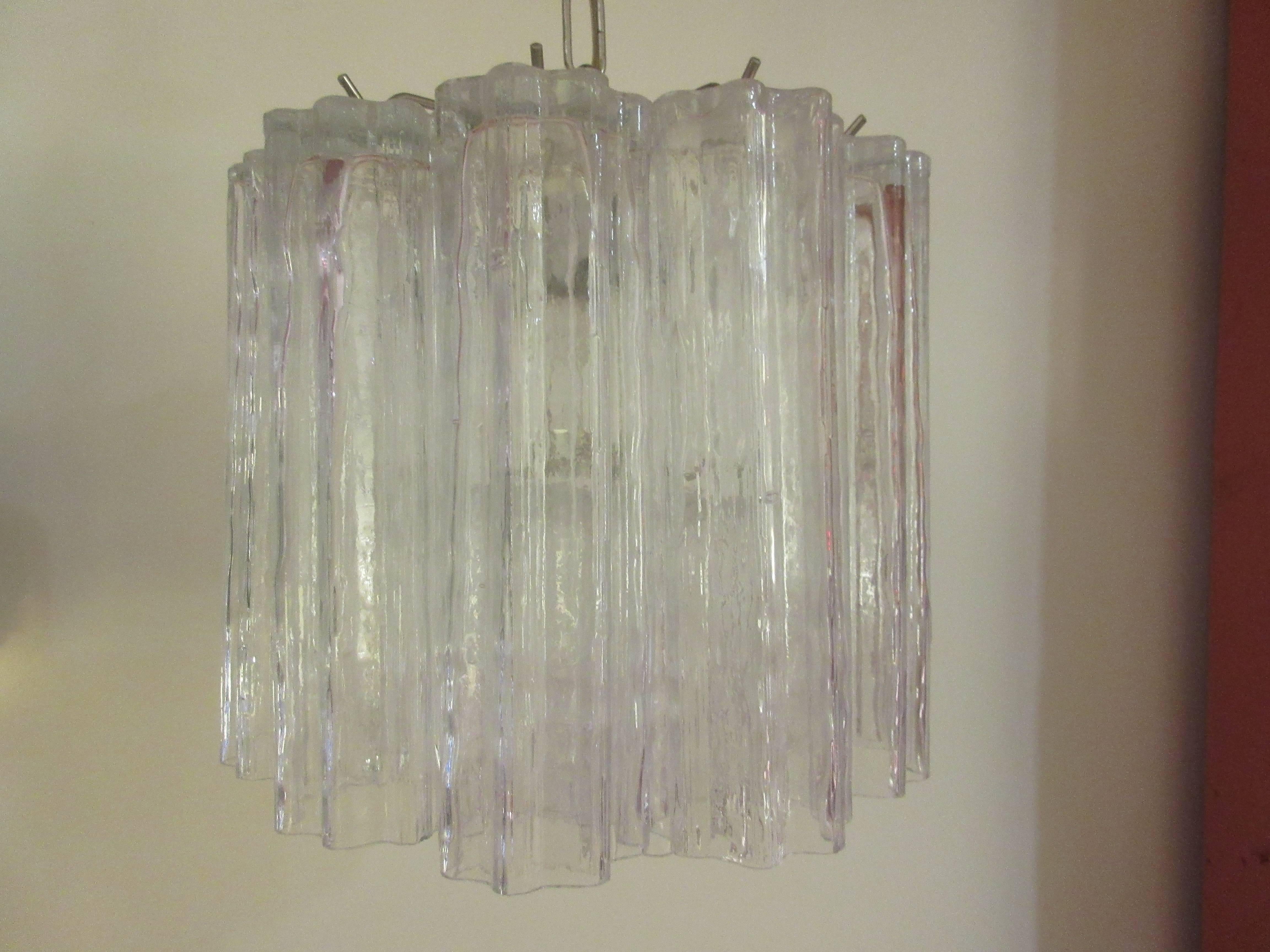 Venini chandelier with chrome accents and 13 of the large open glass shades suspended in two levels. Measures: Each crystal is 10 inches long and 3 inches in diameter. The texture of the glass provides a rough finish which reflects the light source