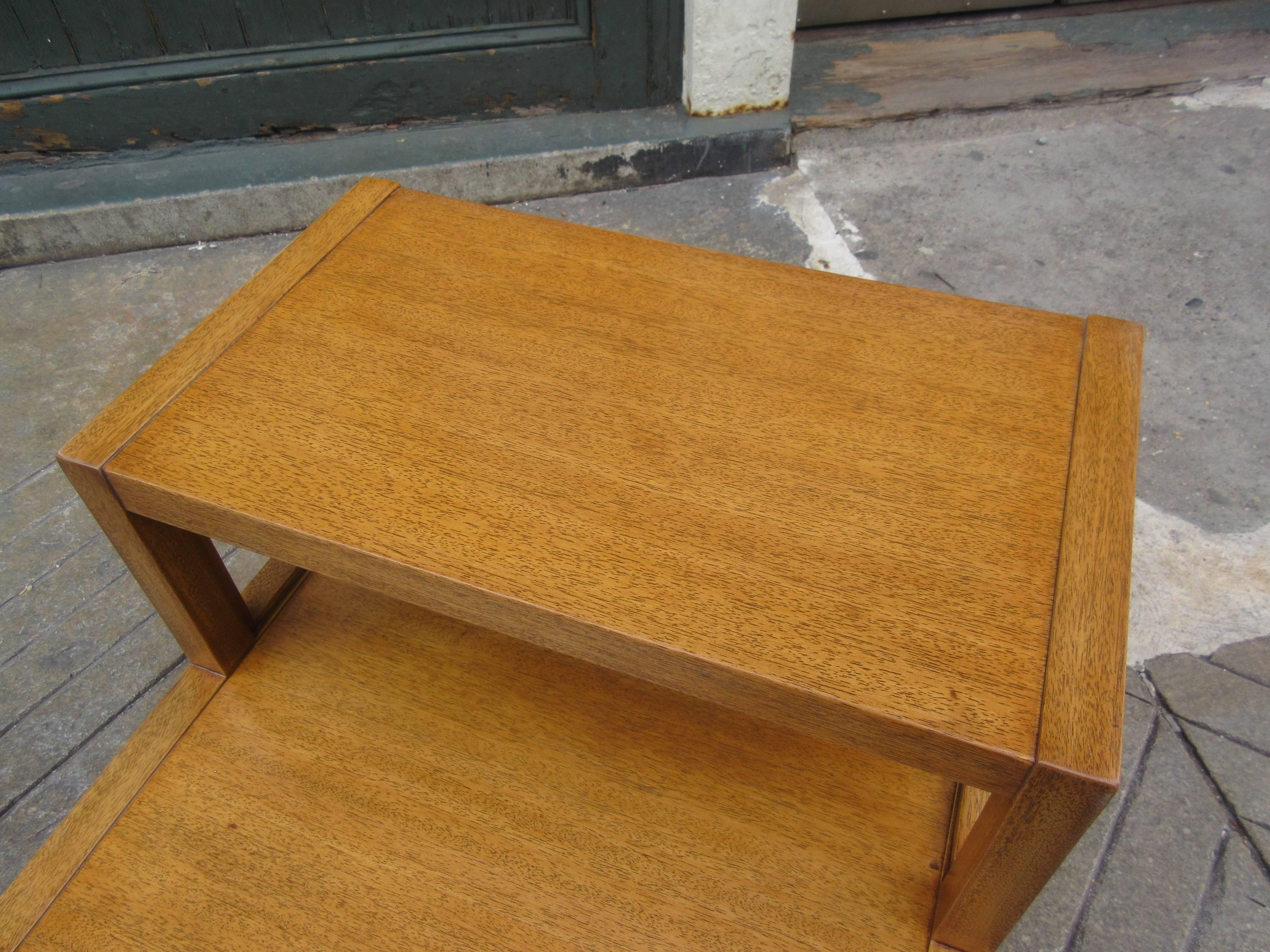 John Widdicomb stepped side table with drawer in honey mahogany with brass ring pull for drawer. Completely refinished and beautiful. For use in the living room or bedroom.