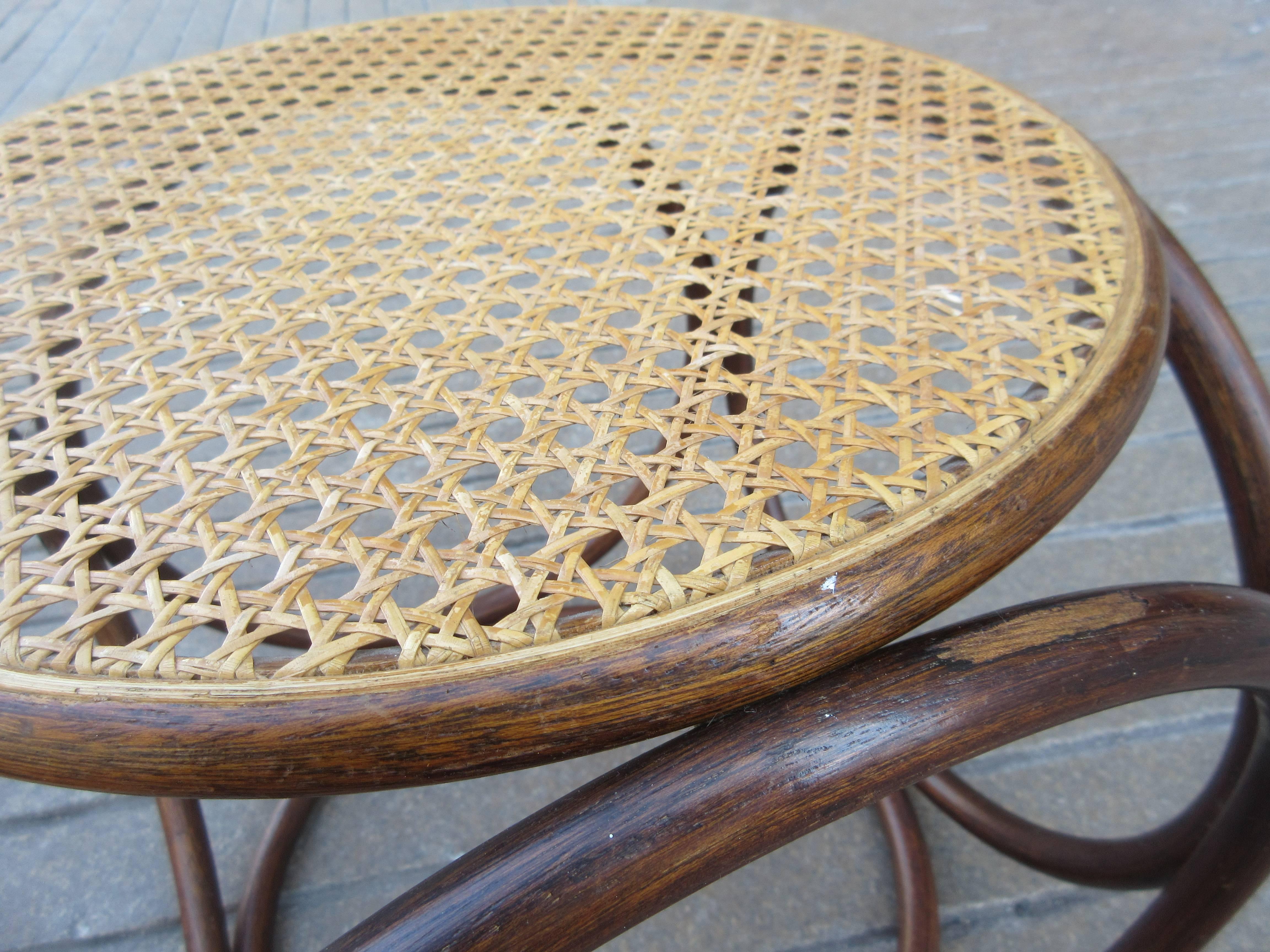 Classic early 20th century design by Thonet. Six bentwood rings make up the construction of this stool or ottoman. This stool's production date is probably 1970s.