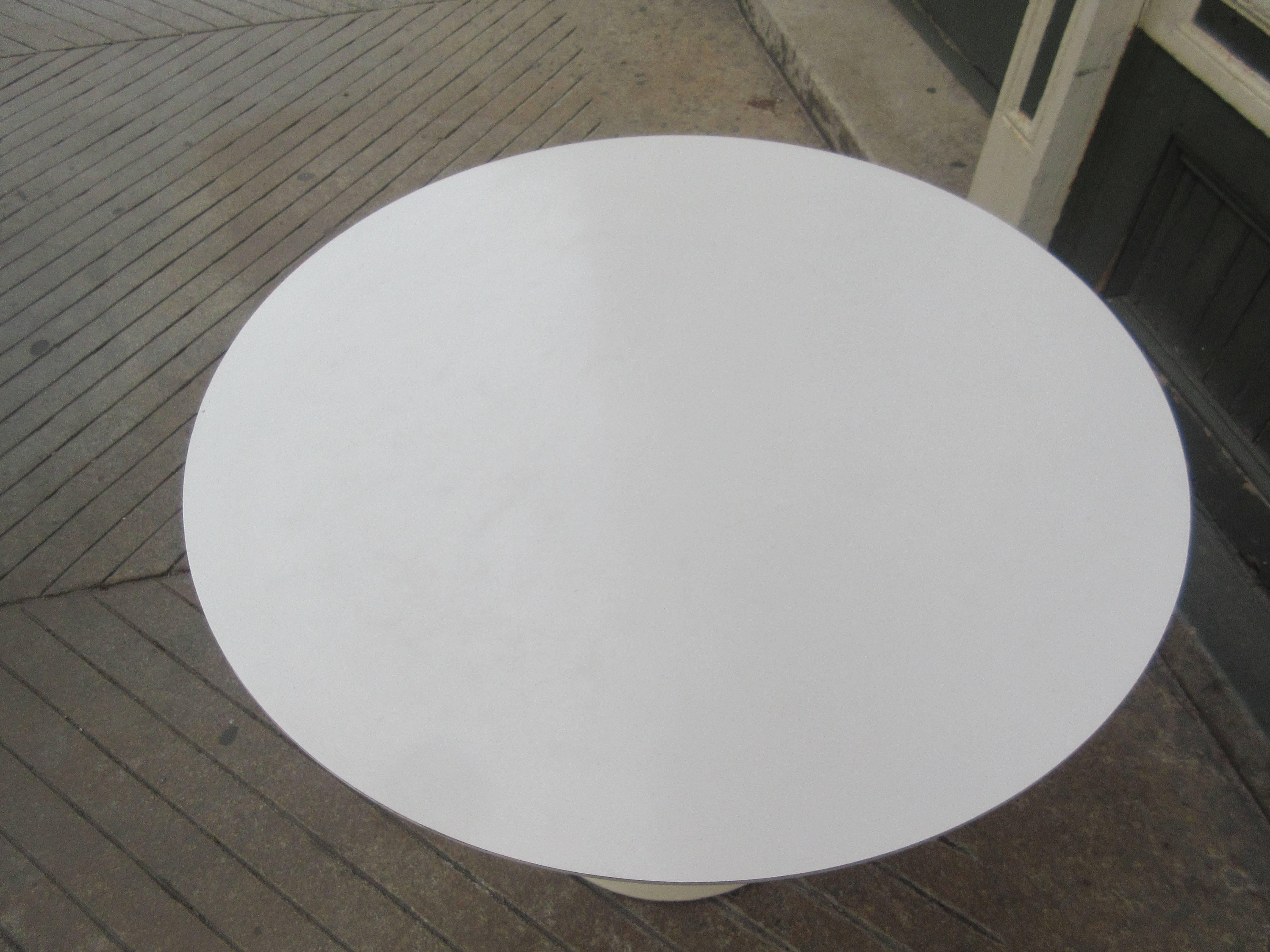 Eero Saarinen for Knoll Associates cast iron base 35.5 inch diameter dining table with laminate top. Cast iron bases were eventually changed to cast aluminum. There is a faint remnant of a Knoll Associates decal.