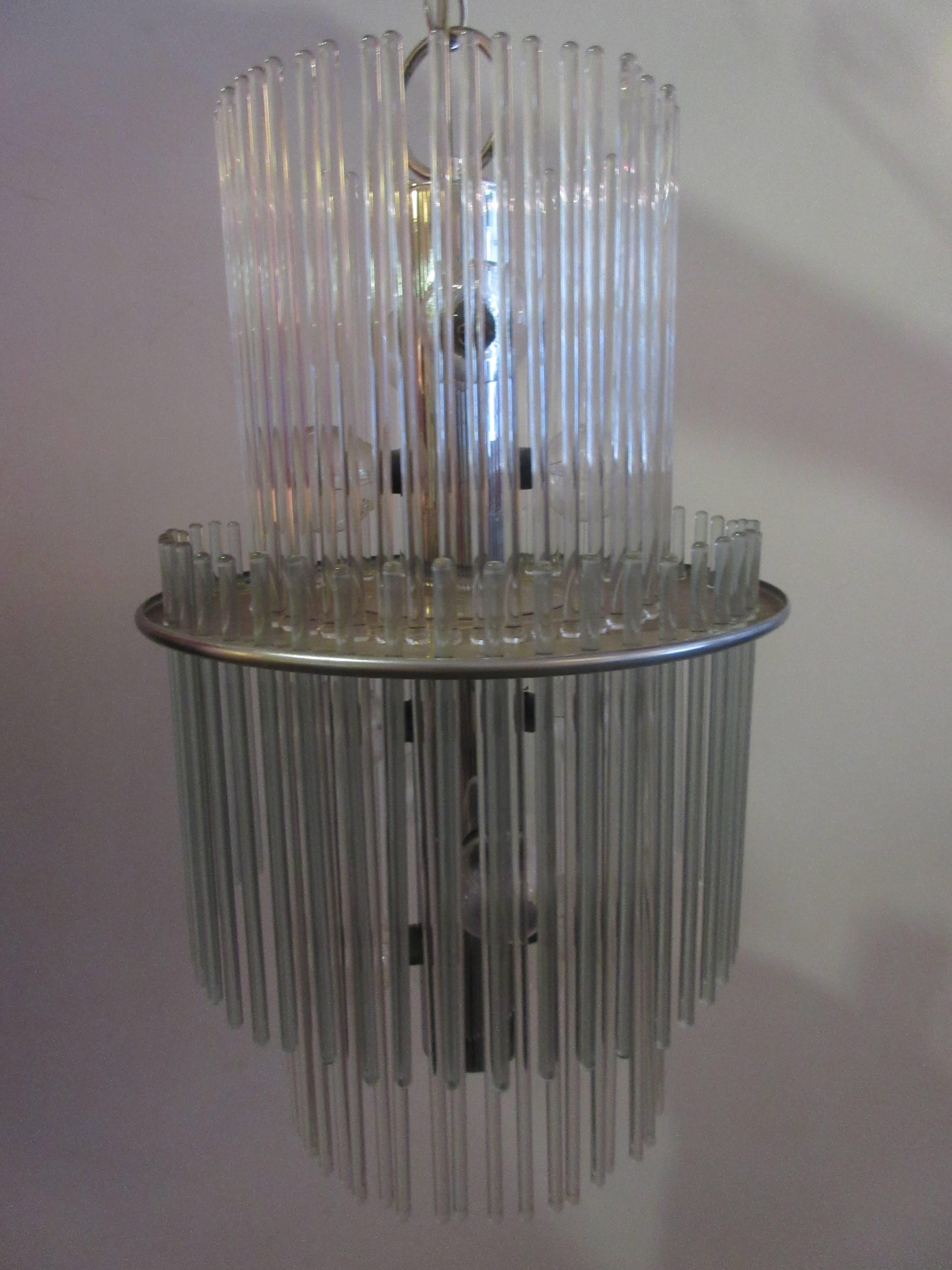 Scolari for Lightolier radiance chandelier with two tiers of glass rods that overlap and twelve-light sockets providing a sparkling light source. Metal is chrome on fixture and supporting chain. Chain is two feet and fixture itself 20 inches.