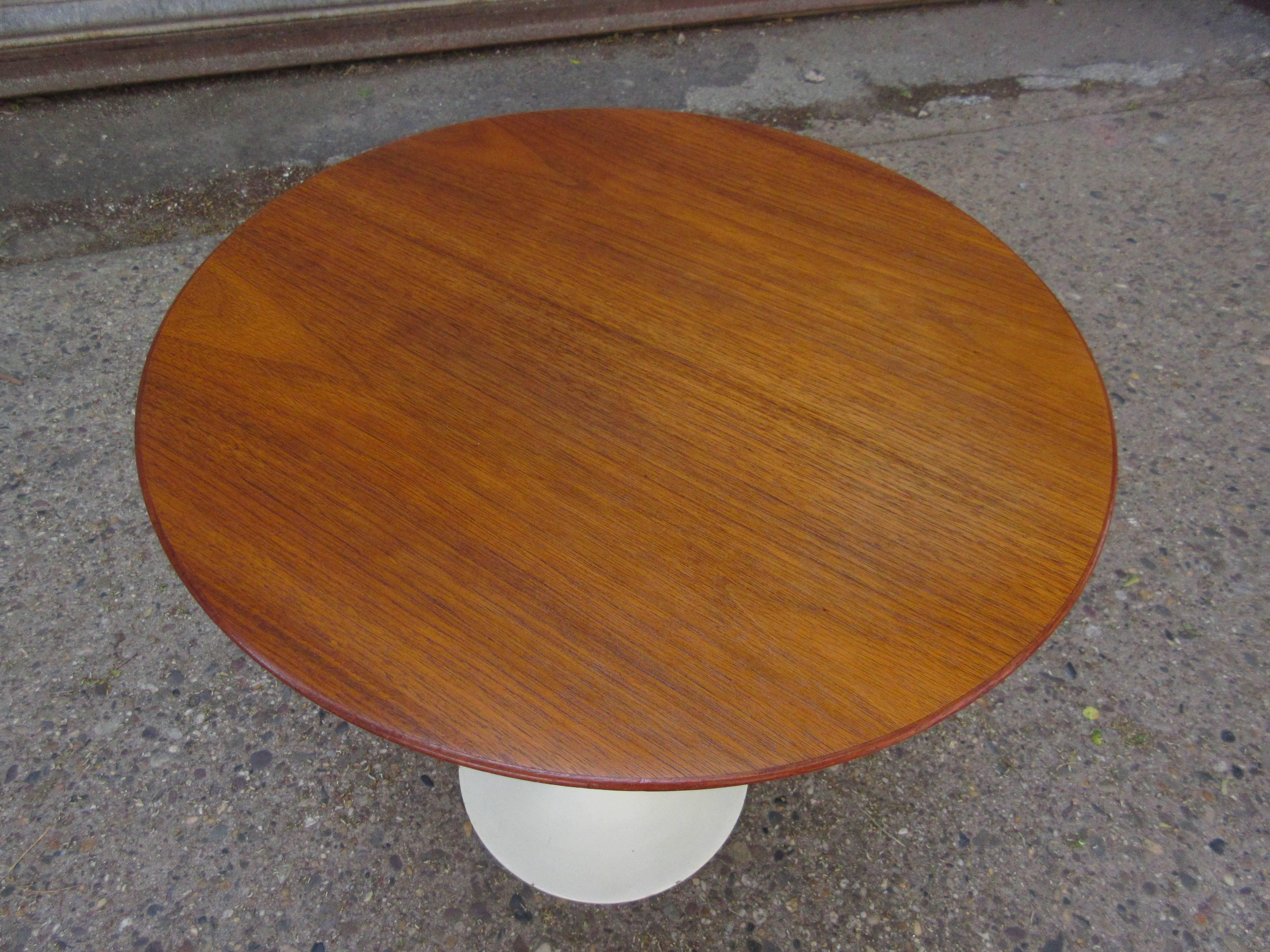 Nice early production cast iron base Saarinen for Knoll tulip side table. Retains its early label. Top has been refinished, but base has original ivory paint in very nice shape, a few minor chips to rim as seen in photo. Measures: 20”.