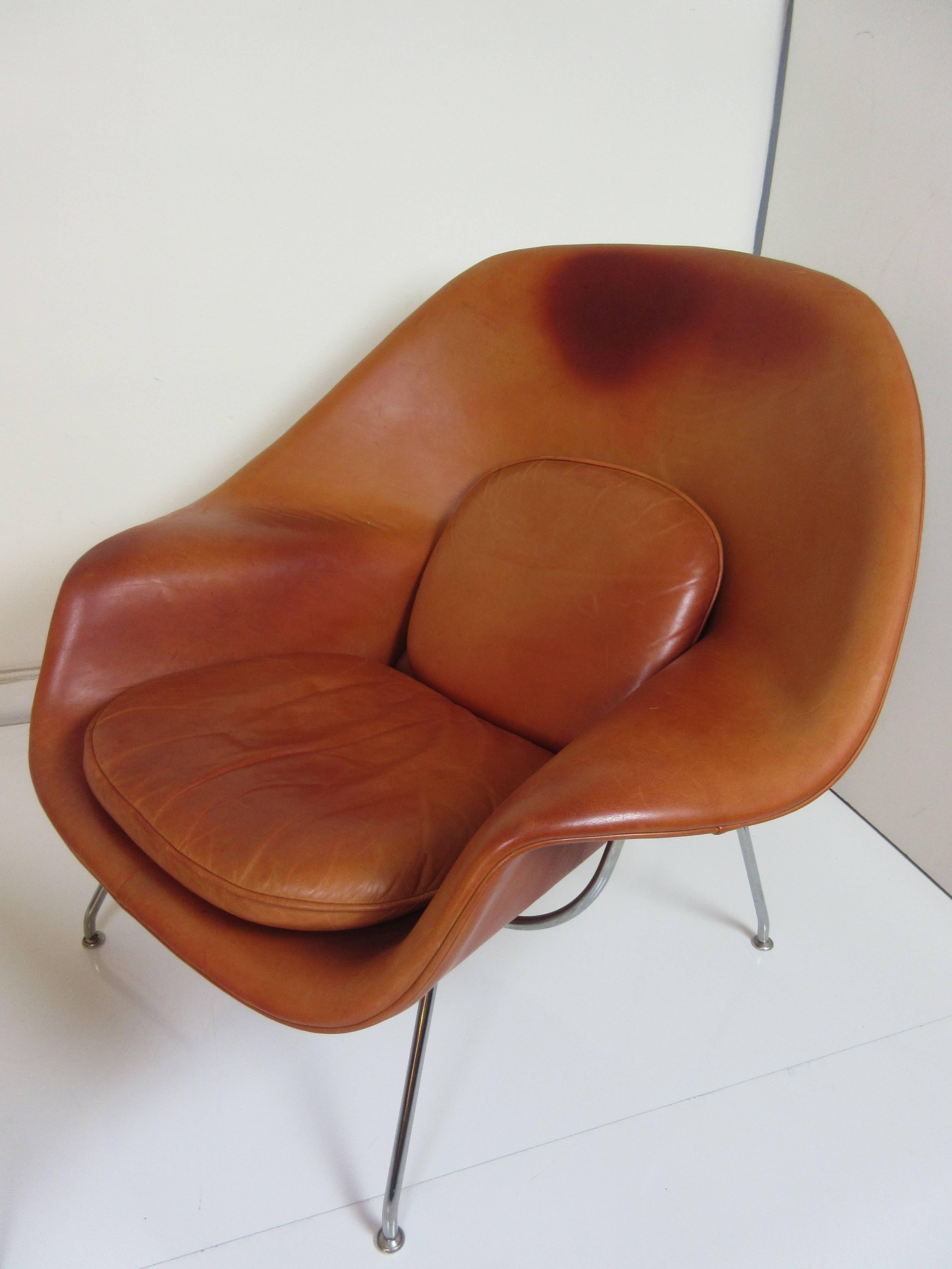 Like a favourite pair of worn gloves, or an old oiled baseball mitt this Saarinen for Knoll Womb Chair and ottoman has a richly patinated Spinneybeck Leather in a Sienna Burnt orange color. Chair and ottoman show a very even faded appearance.