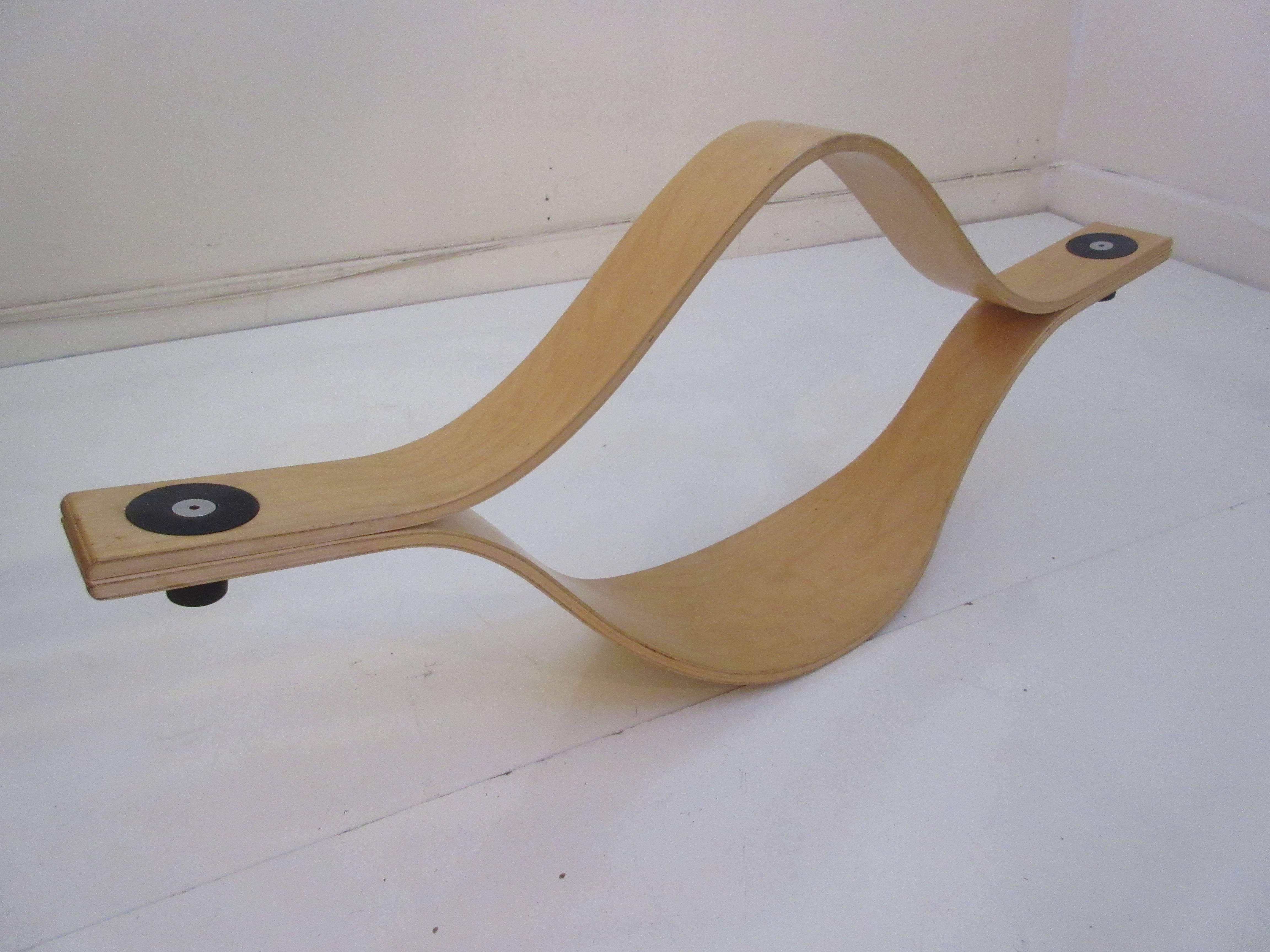 Molded modern plywood see saw by Ikea from the 1970s. Two tapered and bent pieces of plywood are connected with Allen wrench bolts. Rubber bumpers touch the floor when tilted too far. Older Ikea designs are being recognized by collectors for their