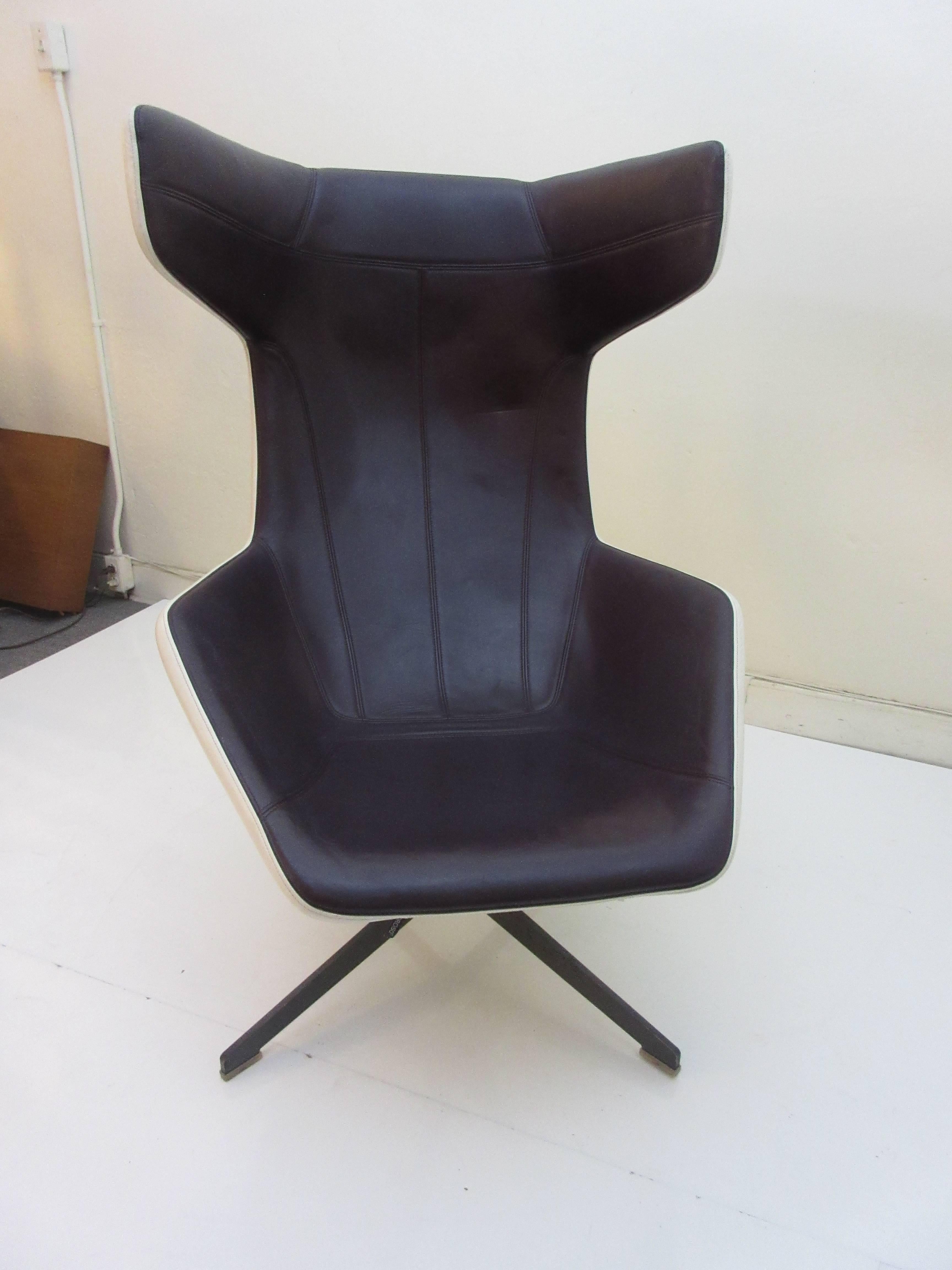 Moroso by Alfredo Haberli take a line for a walk chair after a Klee Paining. This exaggerated deep plum with white exterior leather swivel chair envelops the sitter. The base is solid steel and the fabric label is intact. Designed in 2002 and first