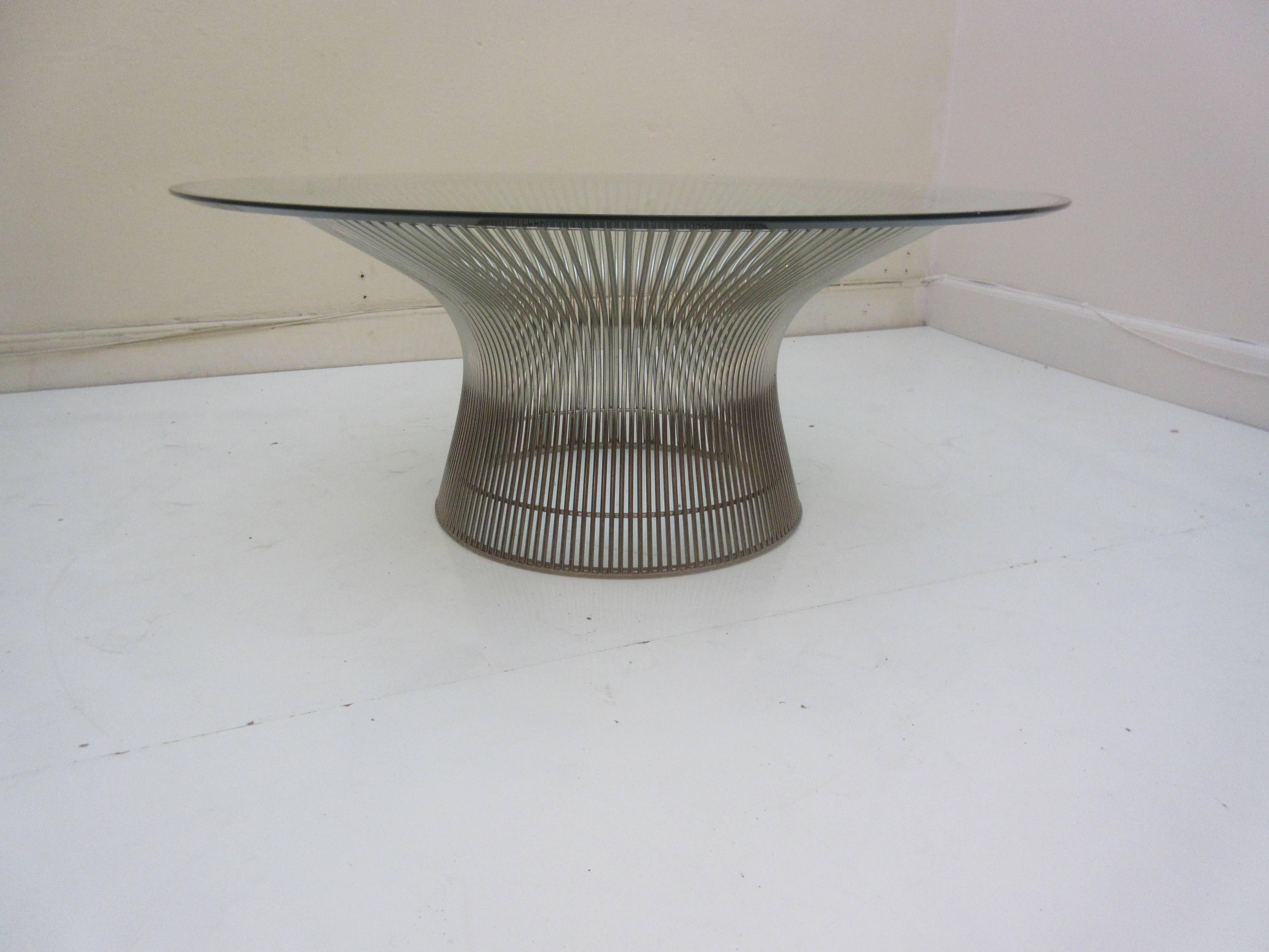 Warren Platner for Knoll International coffee table in the highly polished nickel finish. The glass beveled top is 36 inches in diameter and the base still has it's original plastic ring glide to protect your floor. Metal  in extraordinary