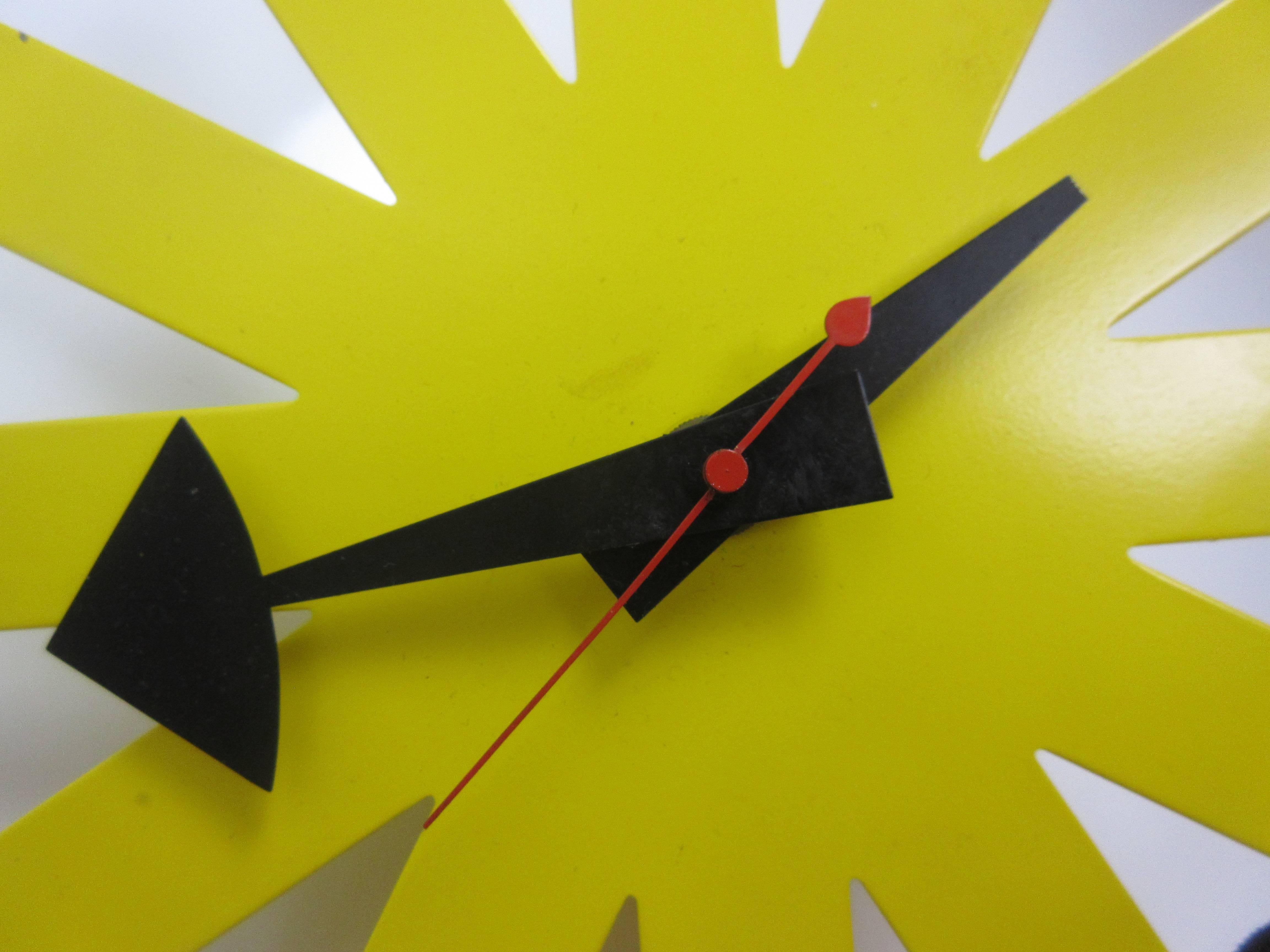 Nice yellow Howard Miller asterisk clock still with its original second hand! Nice bright paint only showing a few minor pin head chips to very edge of clock. Made to plug directly into a wall socket (provided) or can easily be adapted to have