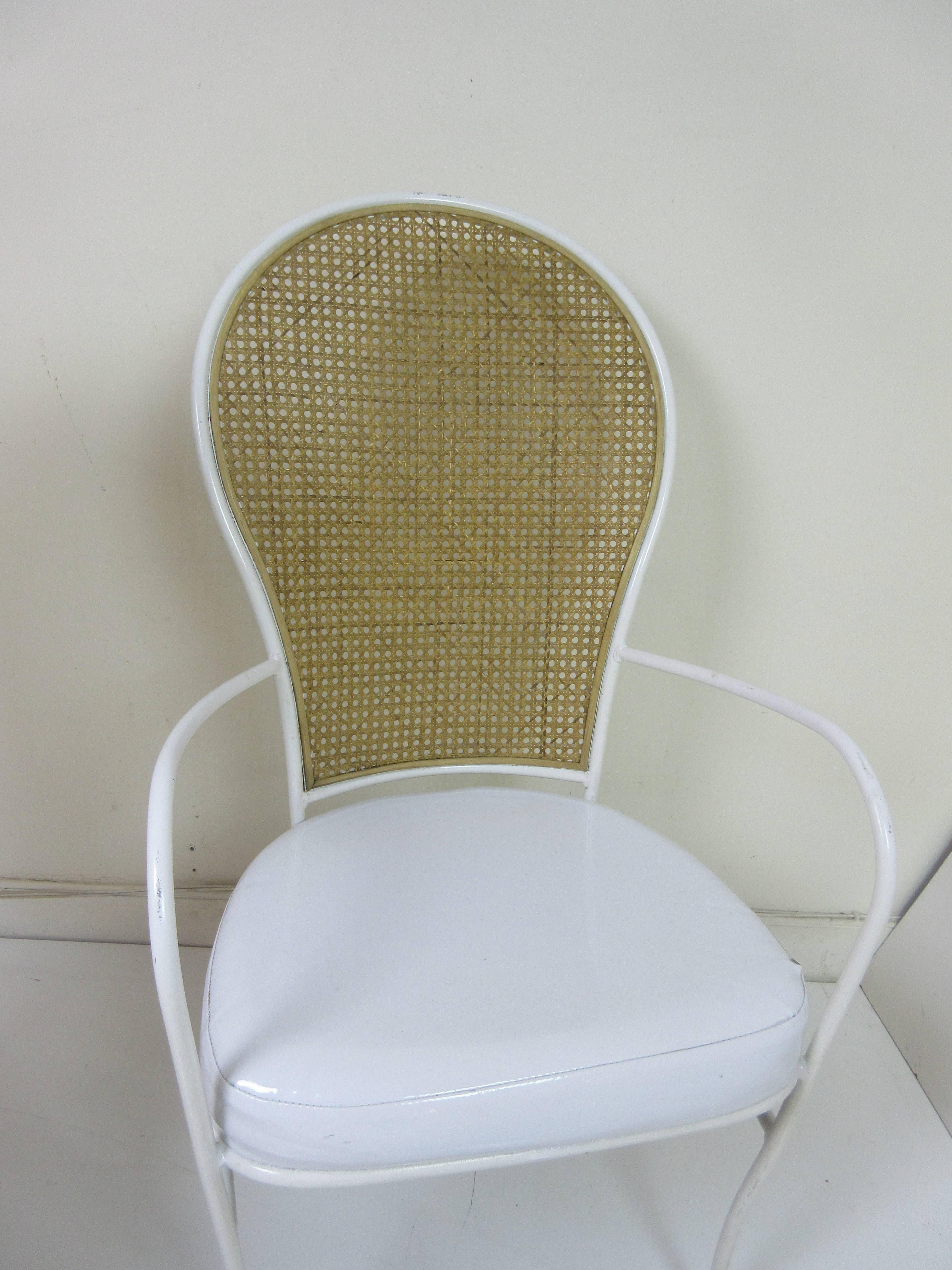 Milo Baughman for Thayer Coggin occasional chairs in white on white with cane backs. Frame is of tubular iron and the seat of "patent pleather". Retains original label and is dated 1974.