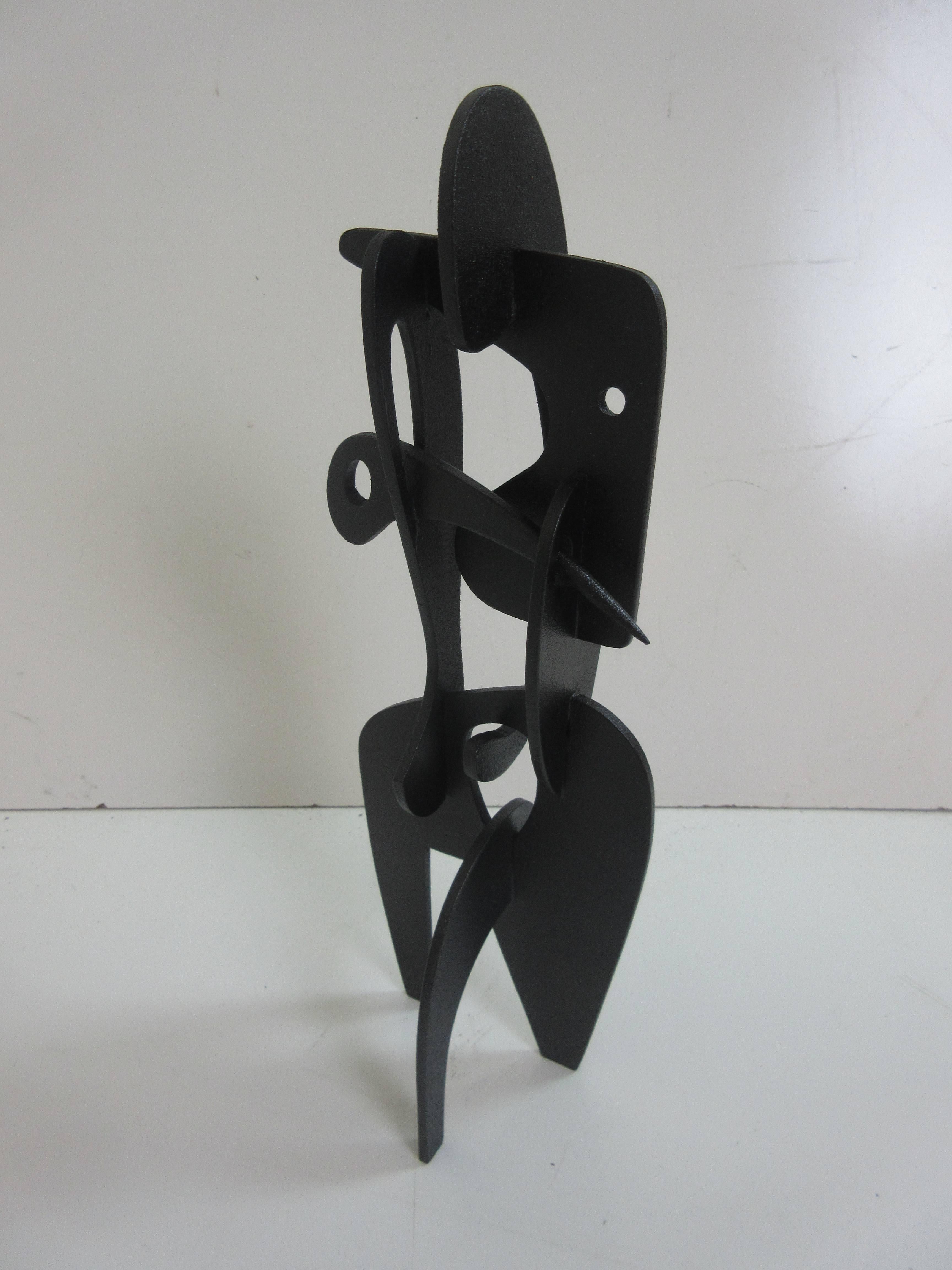 Adam Henderson sculpture female #5 of ebonized wood. All wood sculpture of shaped and drilled flat planes of wood fitted together evoking the female form in an abstracted manner.