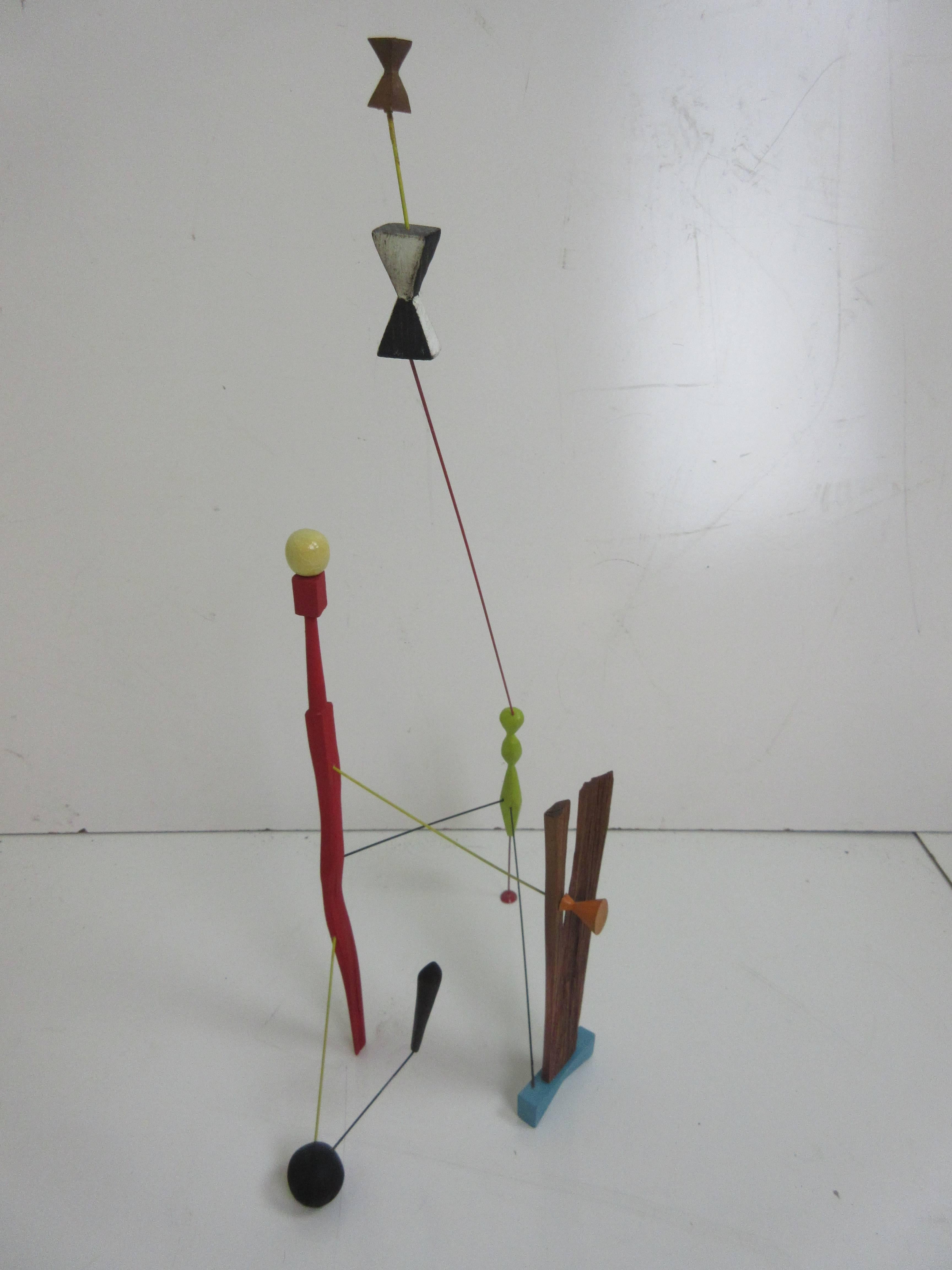 Adam Henderson sculpture tree house #2 of painted wood and ridged wire with one pod foot. Wood pieces not touching the ground seem to soar like box kites. This is a particularly colorful piece with chartreuse, red, turquoise and one piece of raw