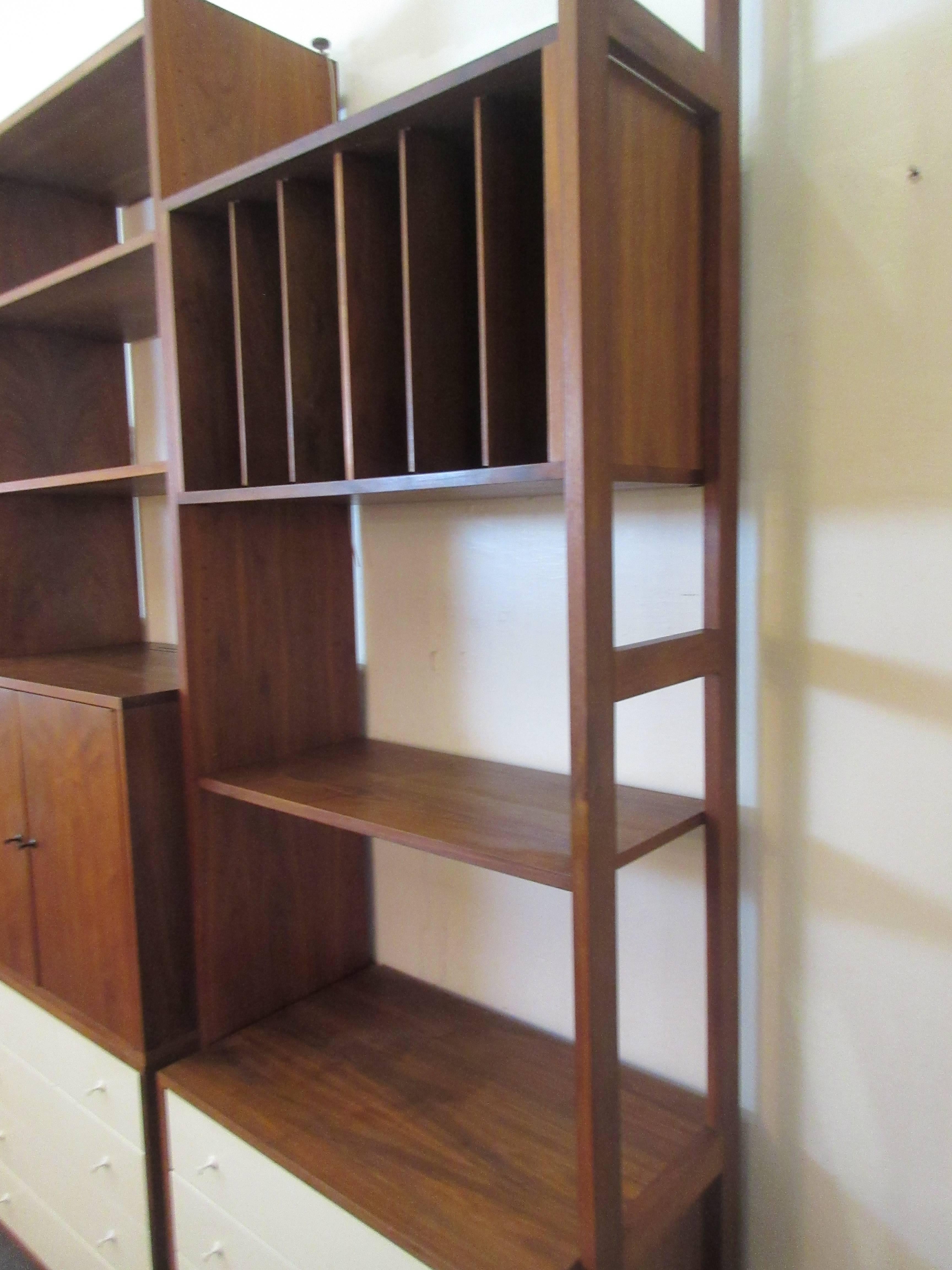 Hardwood house wall or room-divider shelving system with an infinite combination of possibilities. Unit is both for against a wall or freestanding as a divider. Cabinets can be positioned to face either direction when used as a divider. Included are