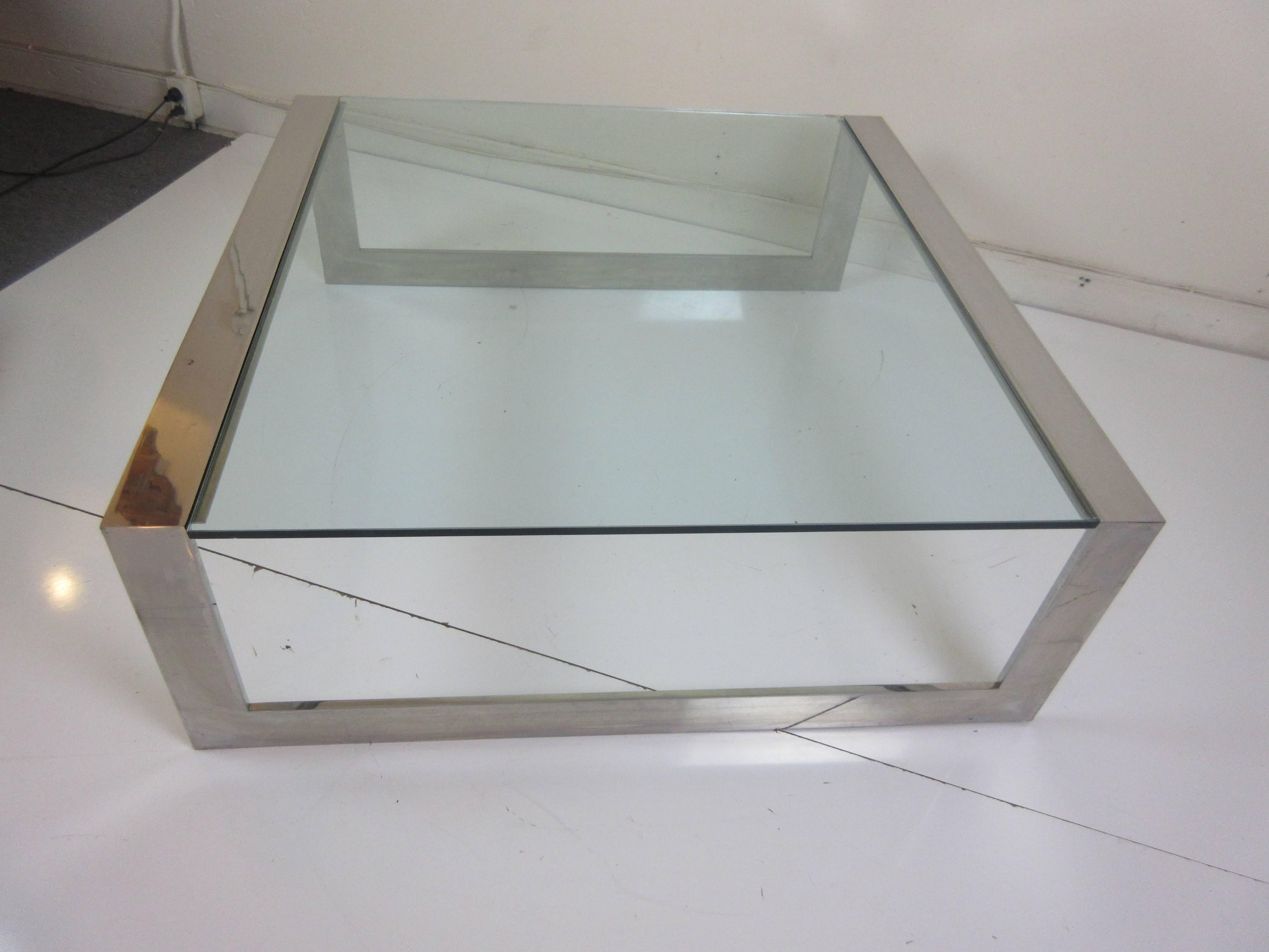 1970s Pace stainless steel and glass coffee table by Lee Rosen. Angular frame supports a 1/2" piece of glass. Simple Classic design! Brand new glass!