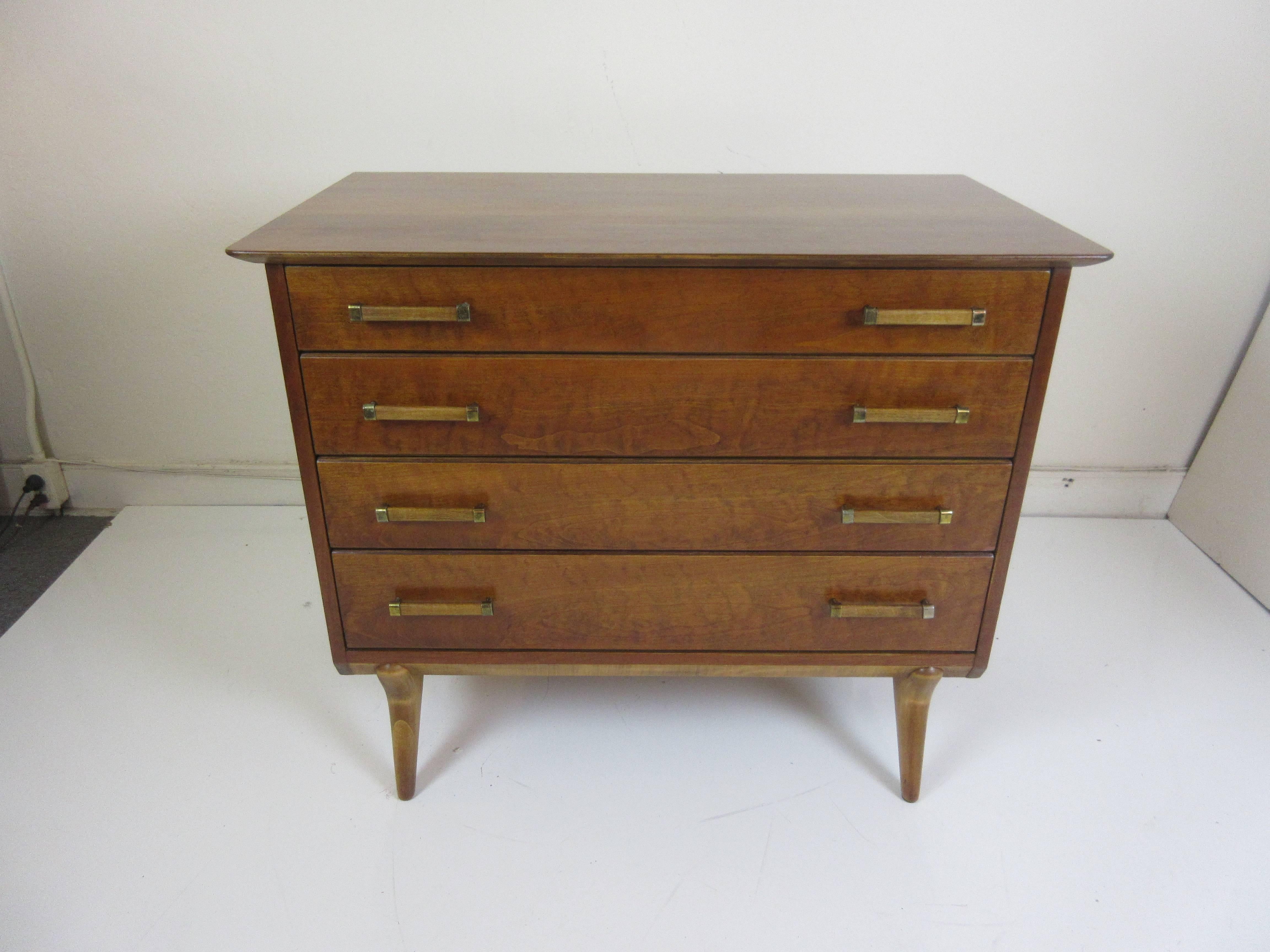 Very nice four-drawer dresser with two-tone accents to legs and handles. Renzo Rutili for Johnson Furniture company. Refinished and ready to go! Legs are blond and front ones angle forward like they are walking! The four-drawer design is probably