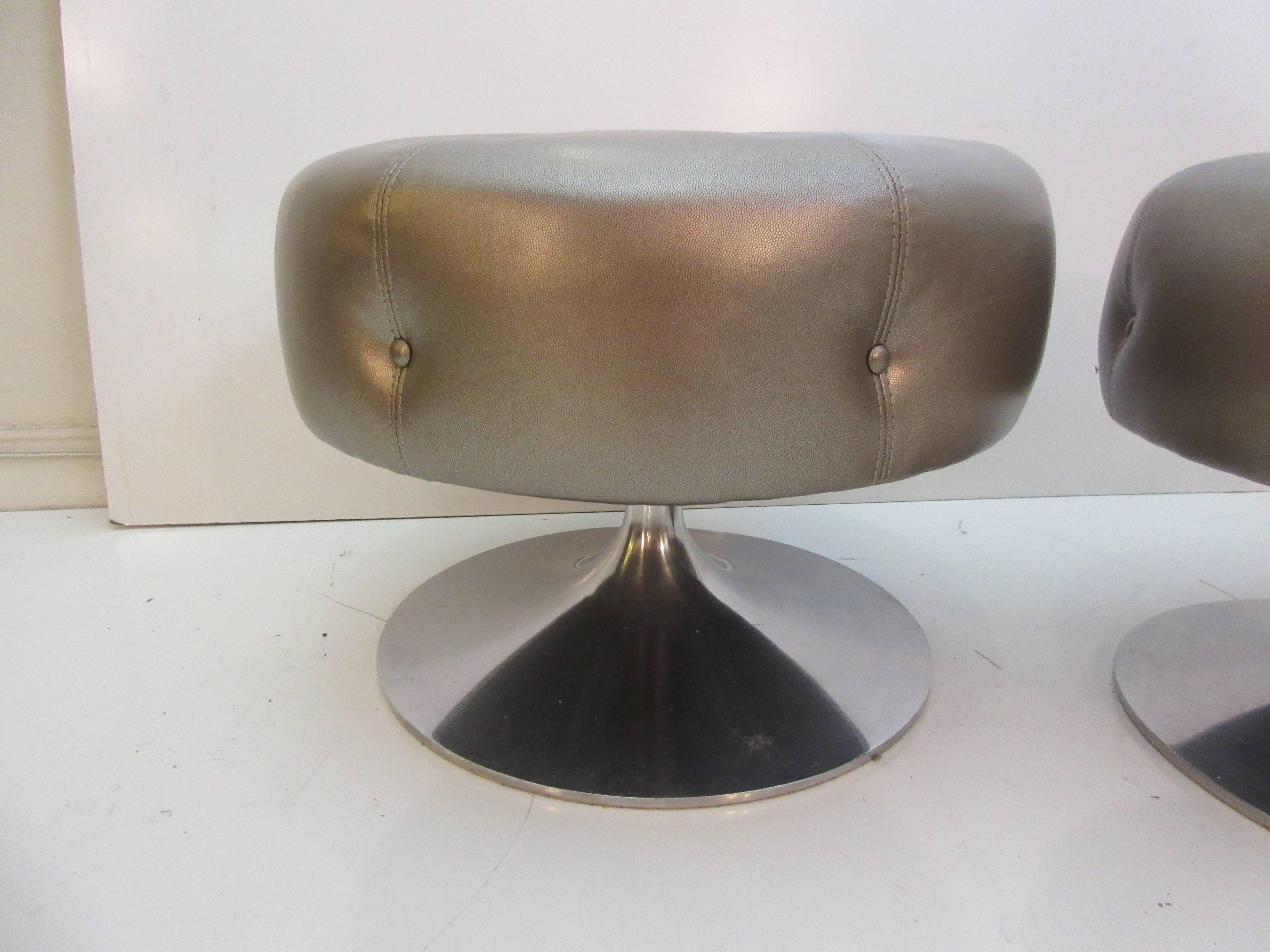 Selig swivelling stools with cast aluminium bases and embossed sharkskin vinyl (close up provided in pictures). Freshly redone from original 1970s unltrasuede. Label still intact.
