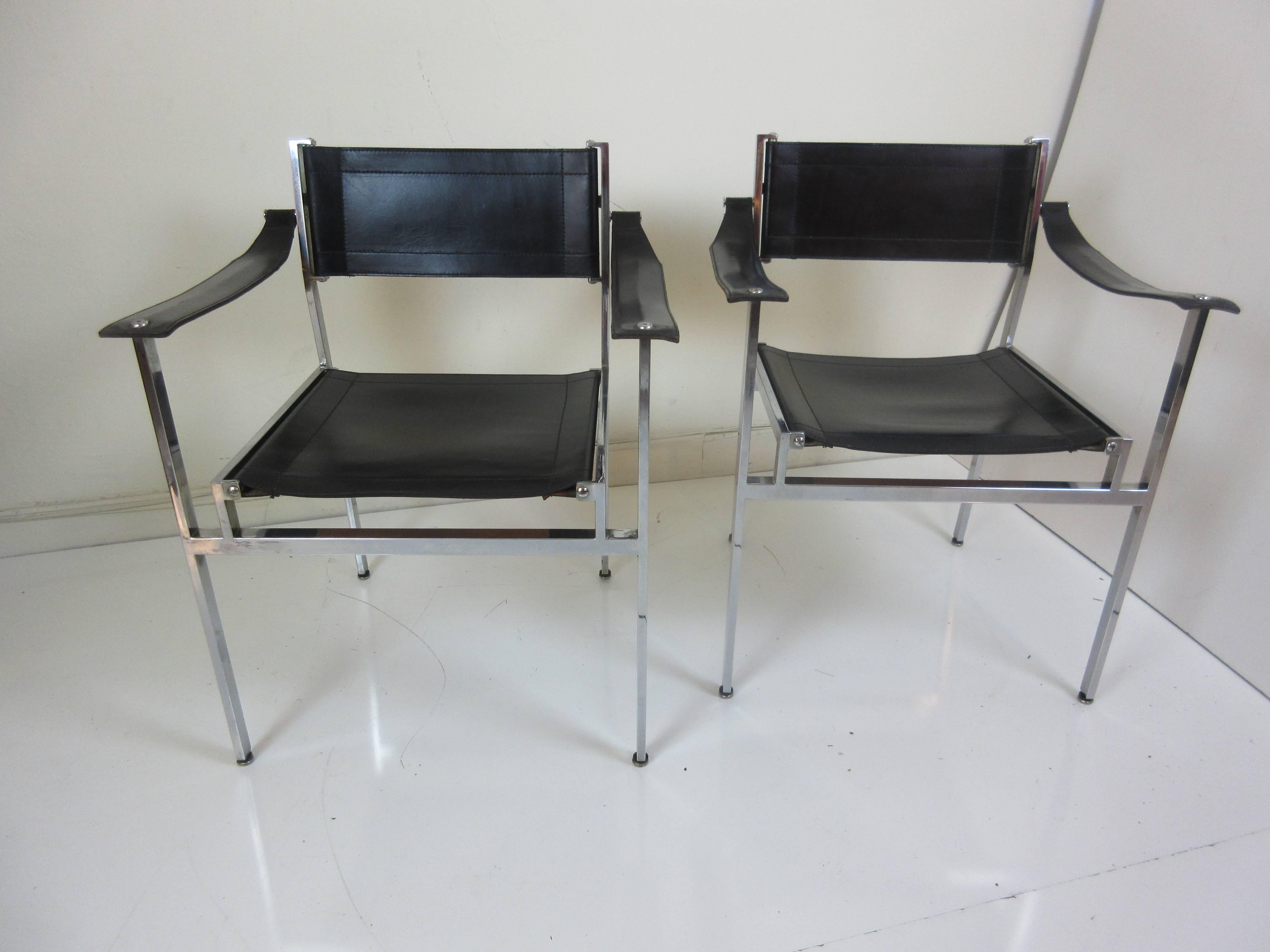Pair of Italian leather Director's chairs with square and rectangular chrome legs and cross members. Heavy leather slings make the seat, arms and backs! Chrome bowed stretcher runs behind backrest.