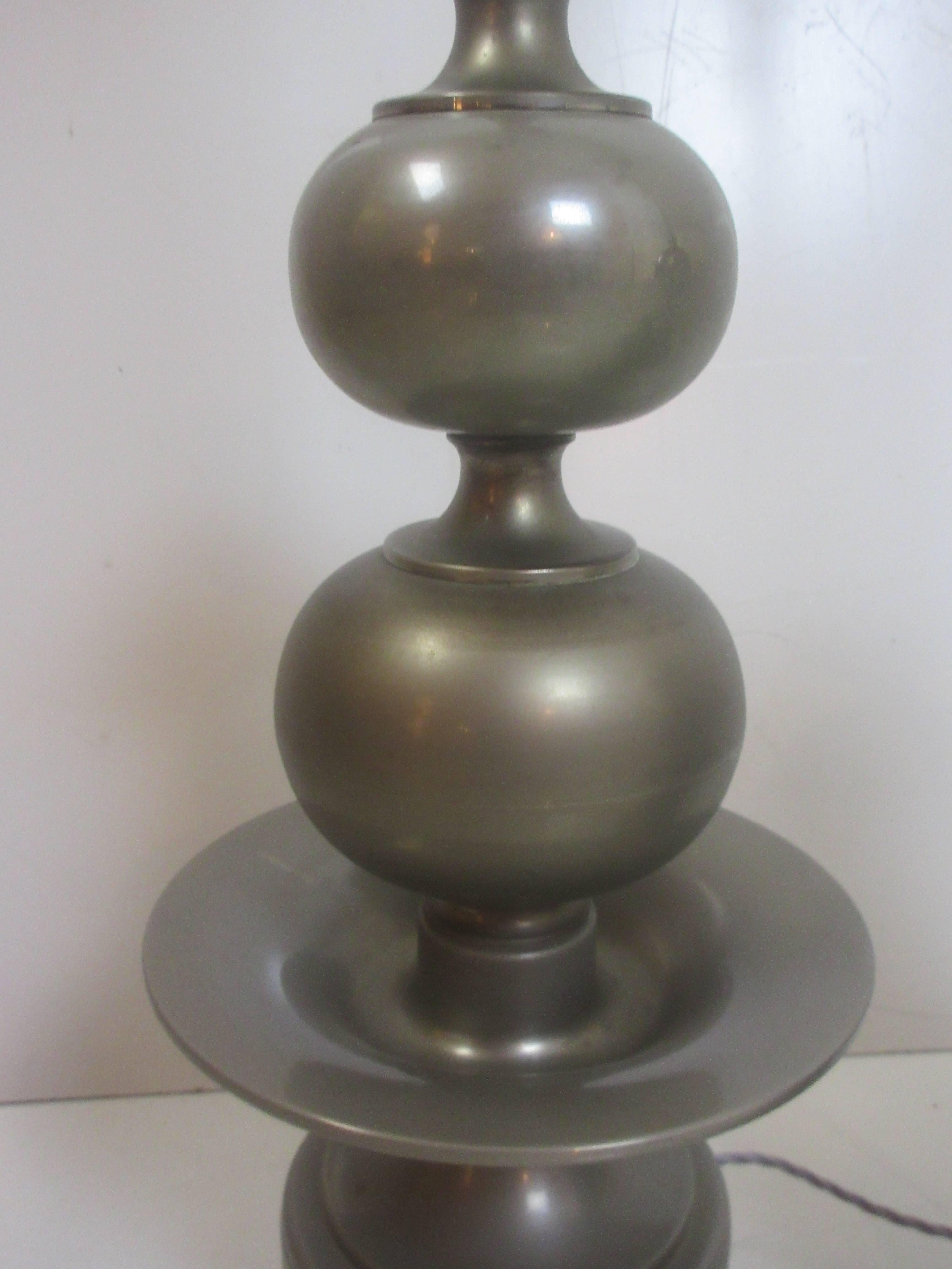 Made in Italy, pair of tall table lamps with a Moorish influence. Pewter gives a softness to the overall appearance of the lamps. Lamps have Directional light shining up from the metal shades and two Directional light sockets pointing down. New Silk