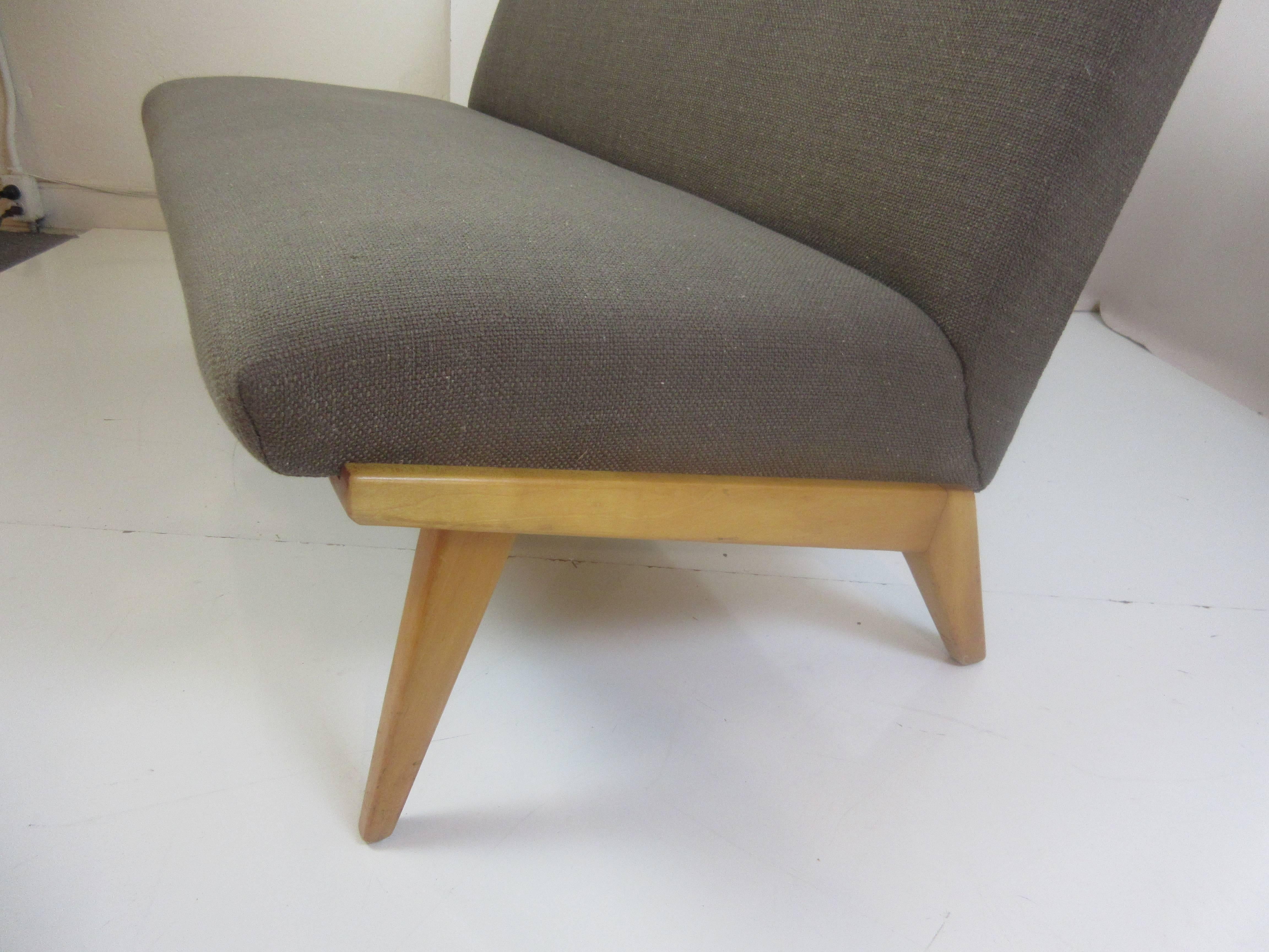 Nice scaled loveseat or settee designed by Jens Risom for Knoll in the early 1950s. This example has been reupholstered in a brown nubby fabric.
