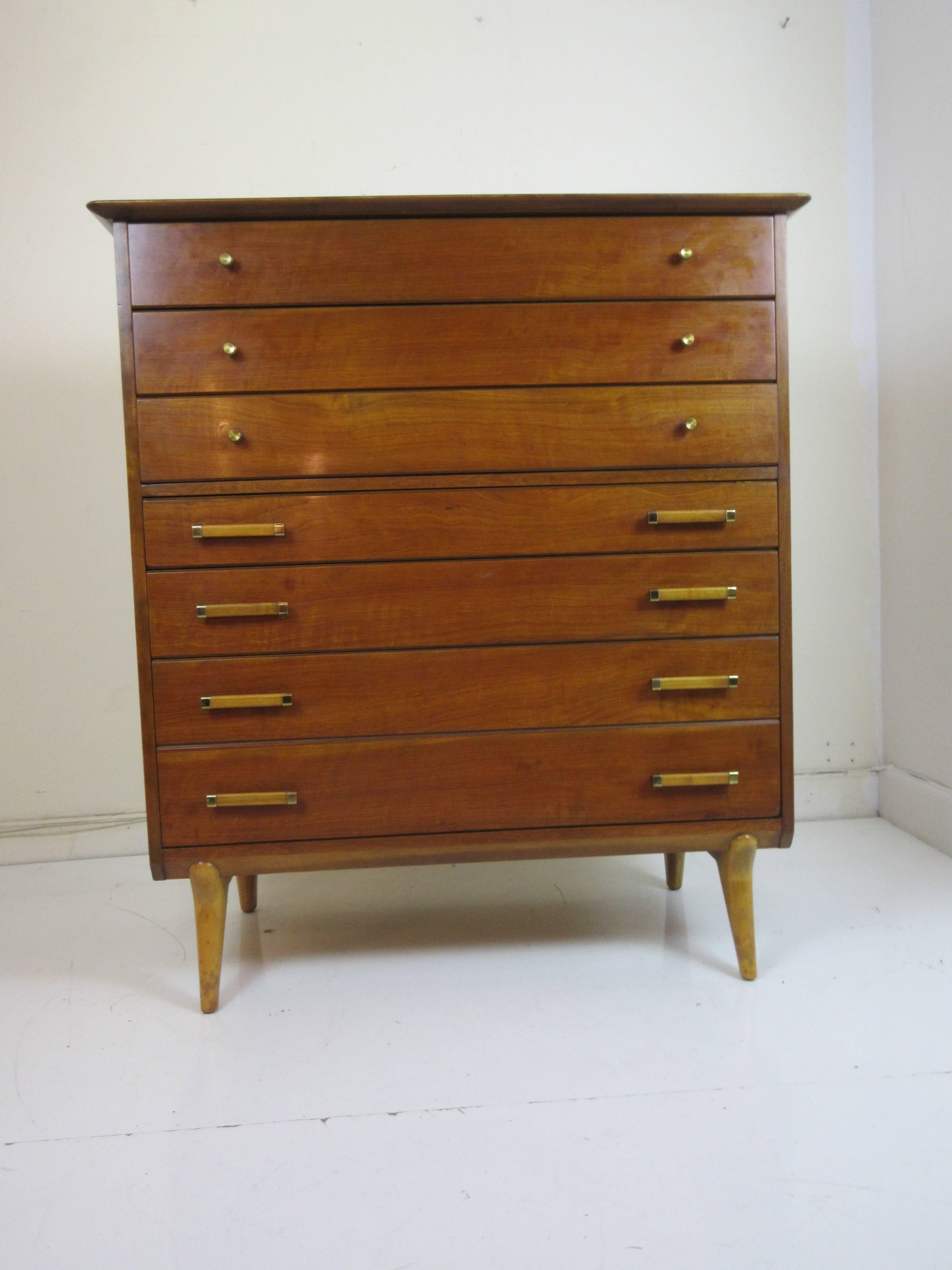 Renzo Rutili for John Stuart high chest of drawers. Rutili's chest with Italian style legs matches a long low dresser and a pair of nightstands we have from the original owners making a complete set if desired. Pulls are of all brass or brass and