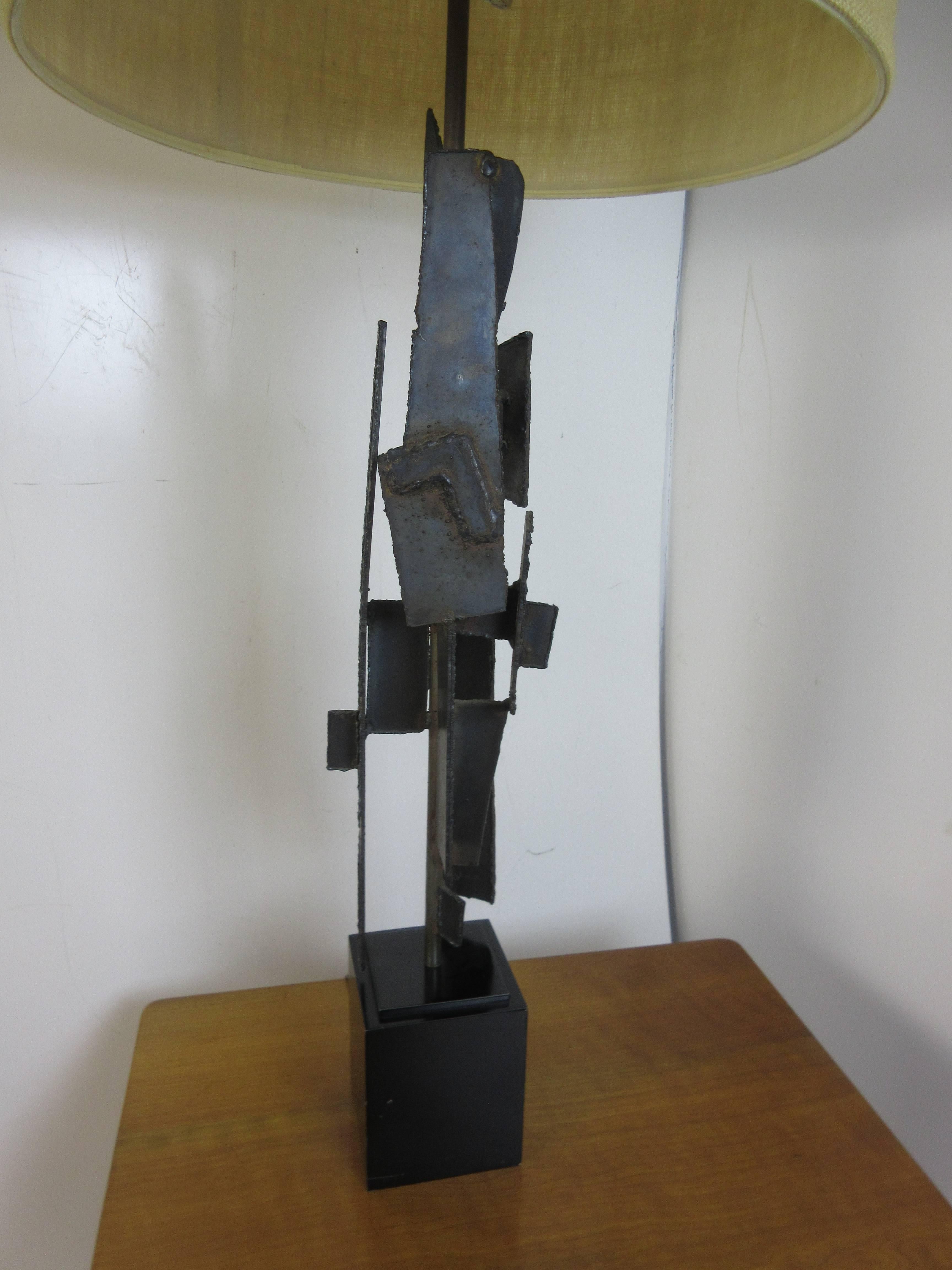 Brutalist Laurel lamp by Harry Balmer in burnished metal. Lamp is show with a shade but that is not included. Trapezoid finial of black acrylic accentuates the welded metal shapes on the lamp. Lamp retains remnant of Laurel Lamp Company decal.