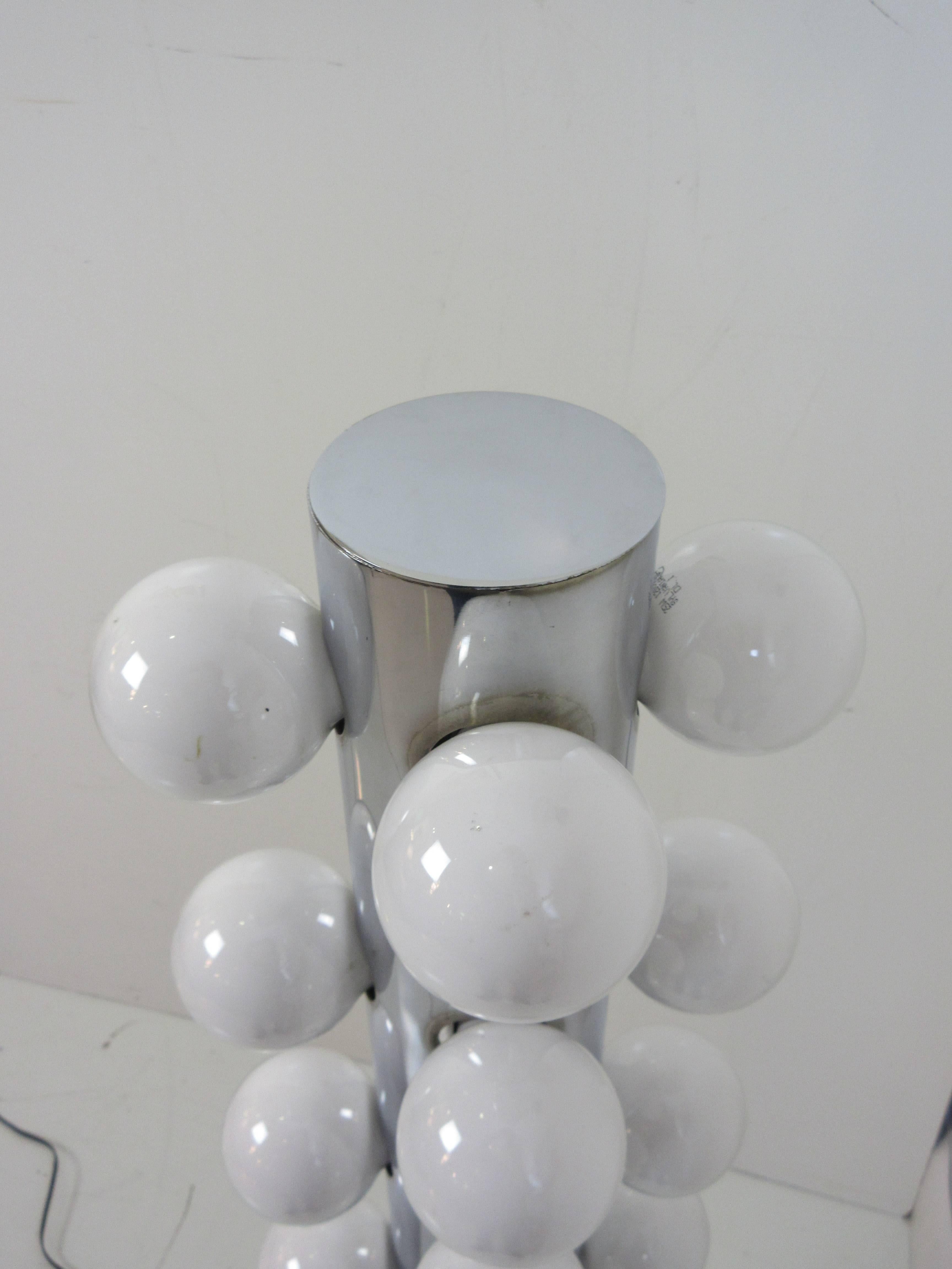 Robert Sonneman floor lamp in chrome with 16 vanity light bulbs on dimmer for infinite possible lighting intensities. This lamp was part of a series of lamps with matching table lamps. Tall cylinder on disk base rises four feet with bulbs on the top