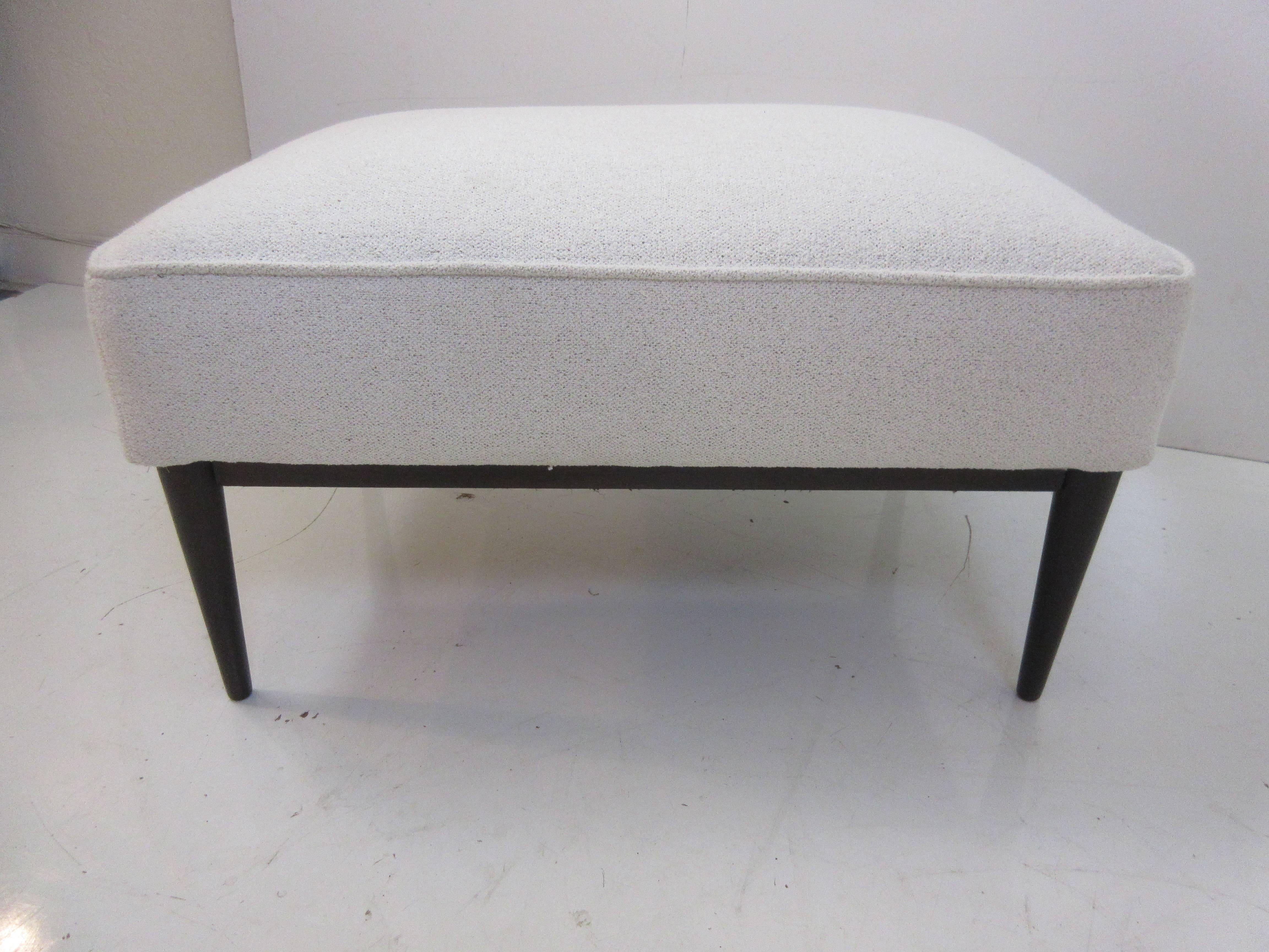 Paul McCobb for Directional Ottoman recovered in a white woven fabric with dark walnut legs and frame in rectangular shape which works well with several McCobb designs.
