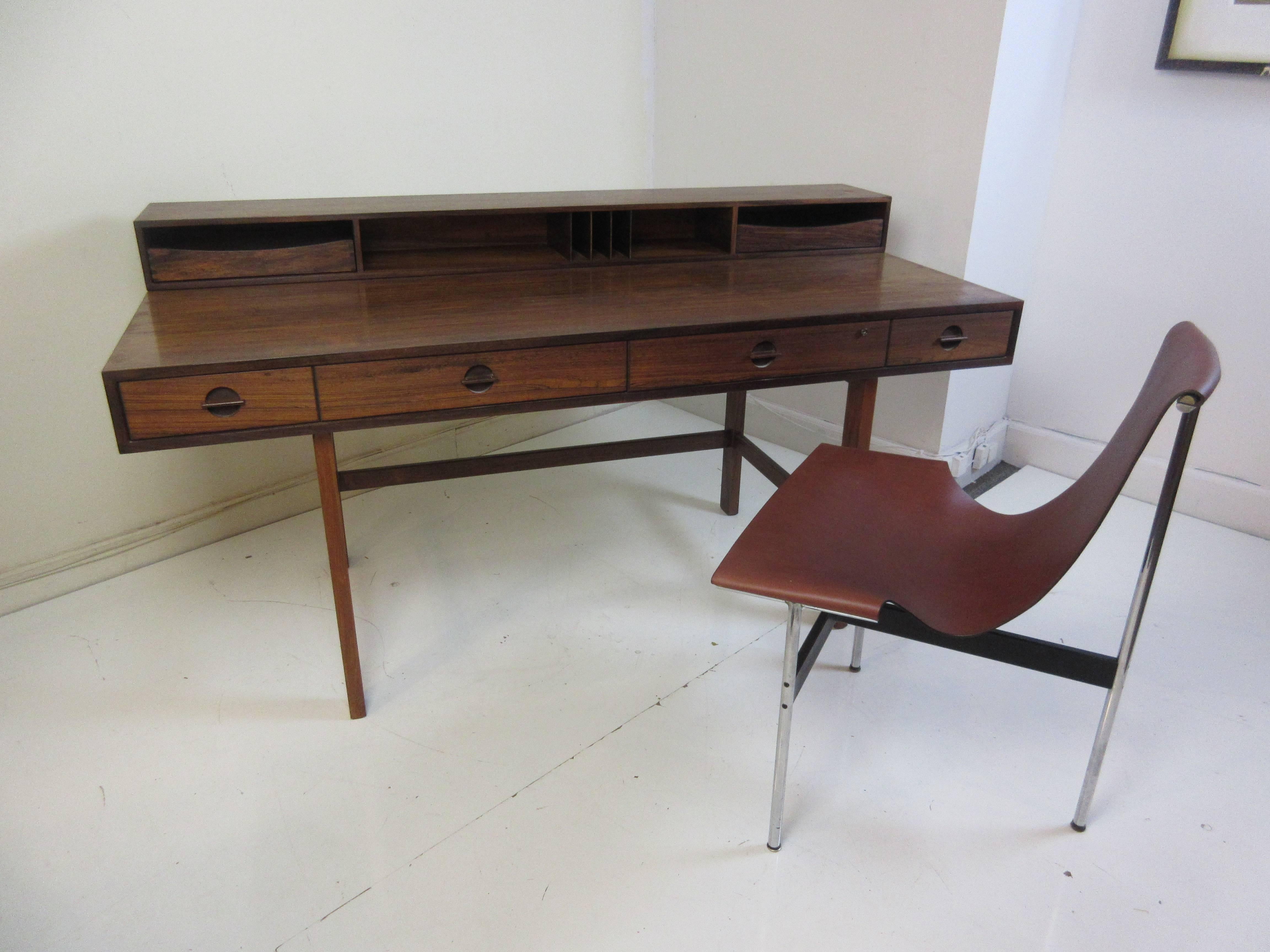 Jens Quistgaard for Lovig in rosewood flip desk . This example was purchased from the original owner architect who bought it in 1961. The upper section flips to enlarge the surface area and in doing so conceals the storage area on the back from