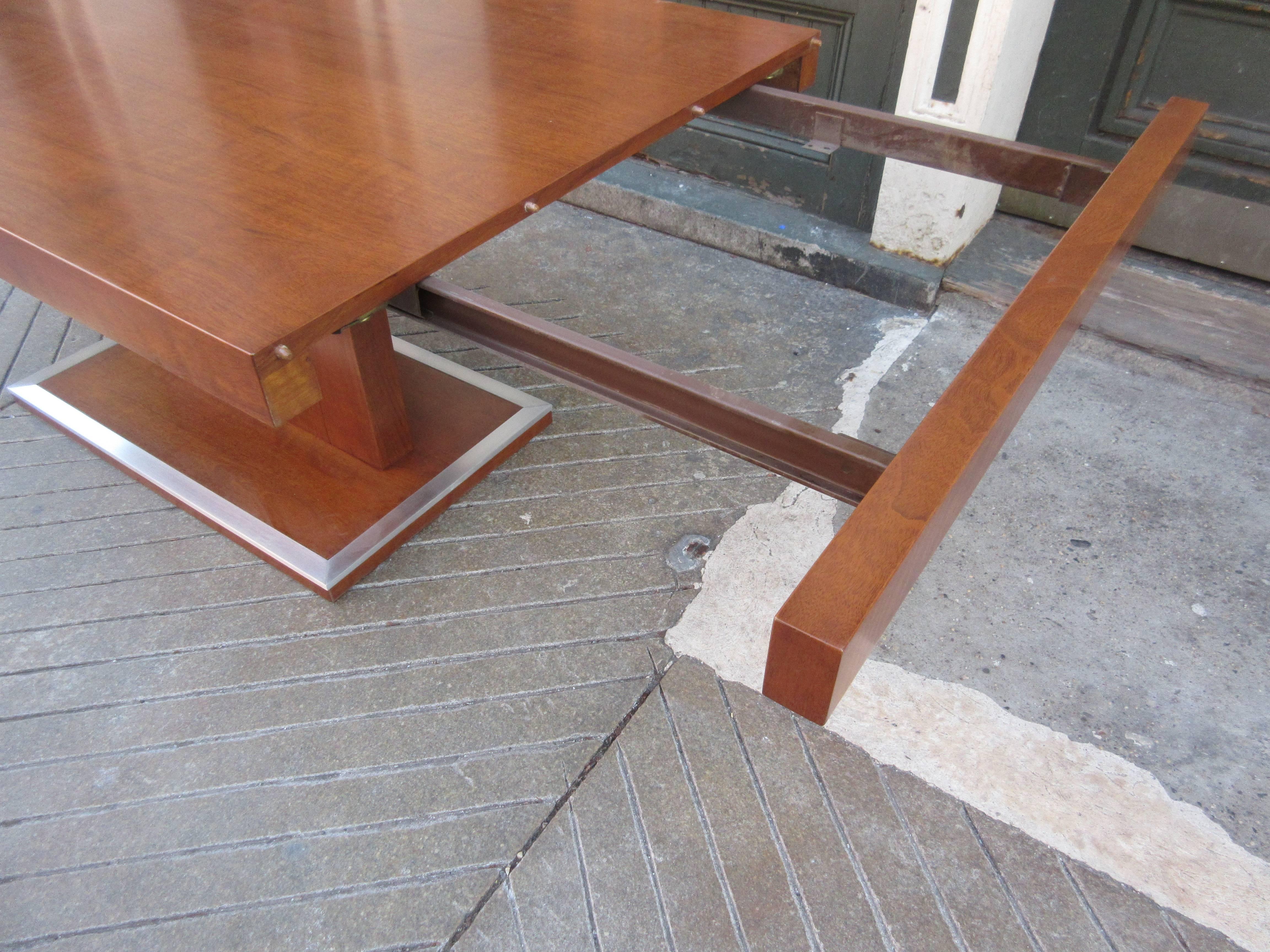 Milo Baughman for Founders walnut extension dining with two leaves totally refinished with aluminium trim polished. Table's dimension listed are for the extended size. Closed the table is 68 x 38. Clearance for arm chairs under the table is 26.5