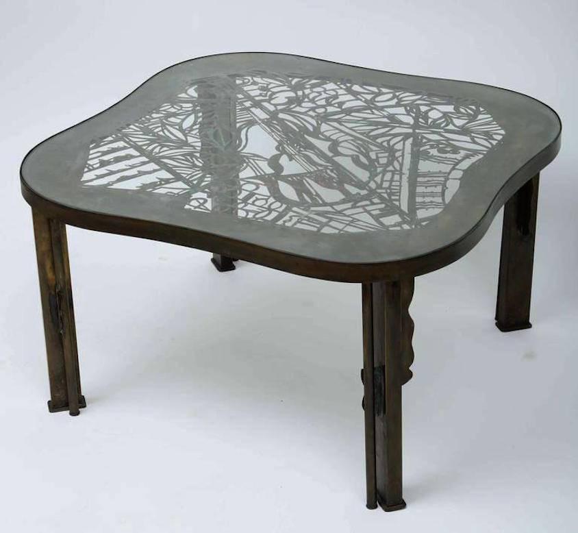 A reticulated and enameled table with a glass top.
Signed.