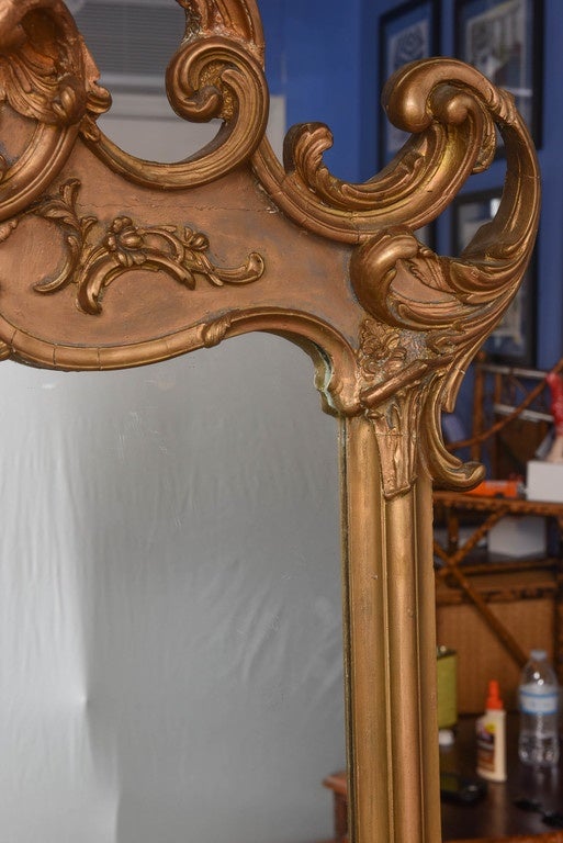 This is a Superb decorative antique french gilt free standing or wall mirror made in France in the 1800s.
The frame is solid wood with very elaborate gesso gilt work to the top and base.
I think at some time it has had some small repairs but