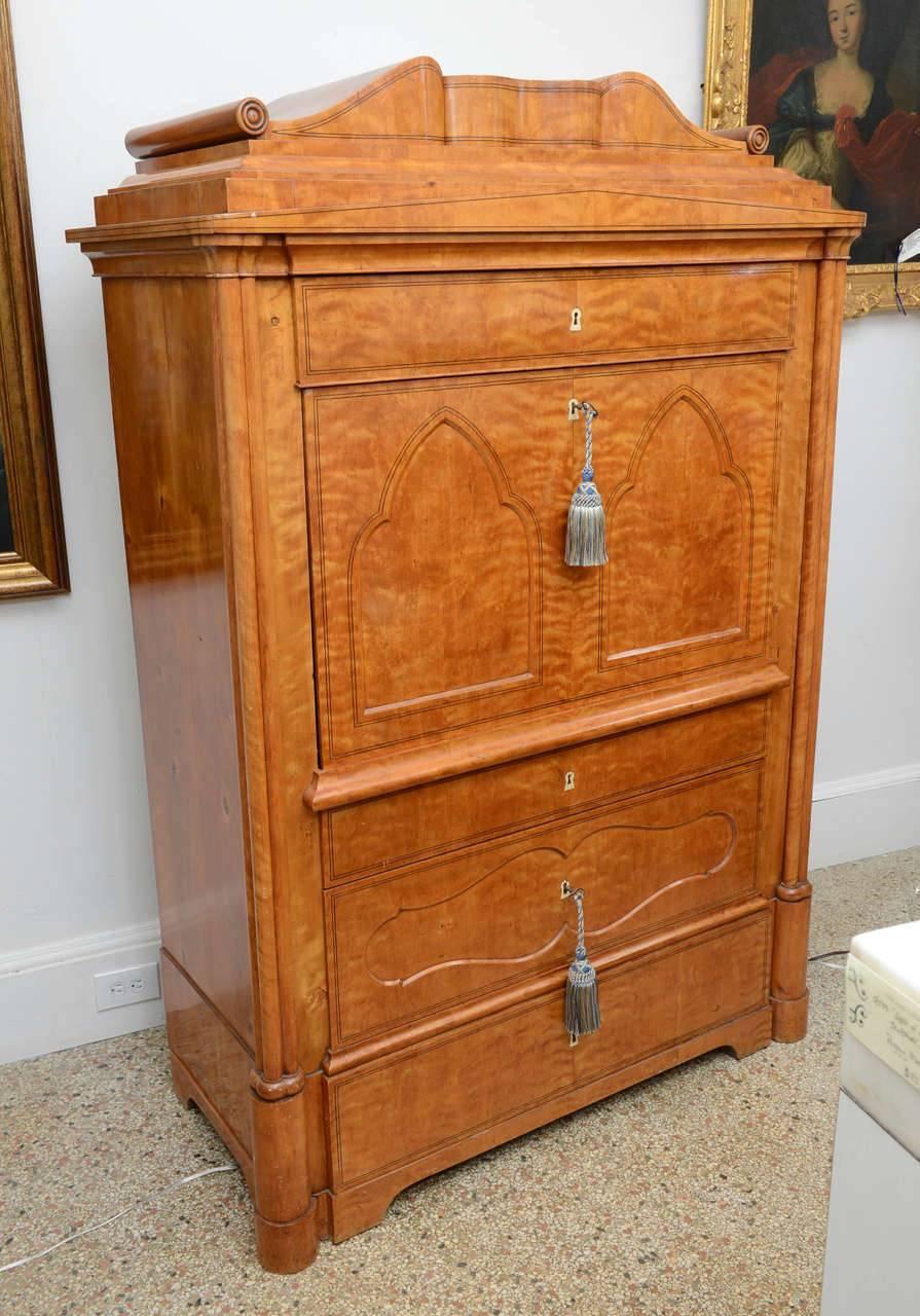 This is a superb quality very unique antique satinwood secretaire a abbatant. A single, full width drawer over the drop front portion and two full width drawers below. The interior of the drop front hold many drawers and doors for storage. It also