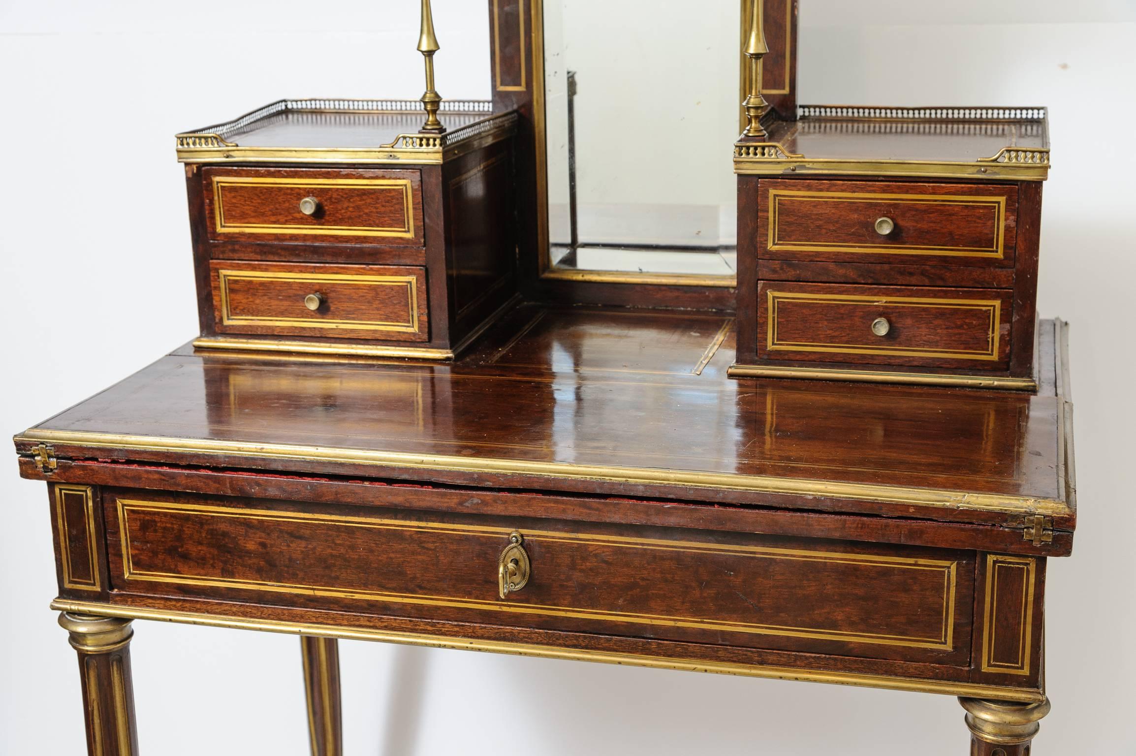 This is a superb example of a French antique ladies writing desk with mirror.
There is a brass gallery to the top brass inlay to the sides, top and legs.
This was made circa 1880 and would have been a very expensive desk when made it has the