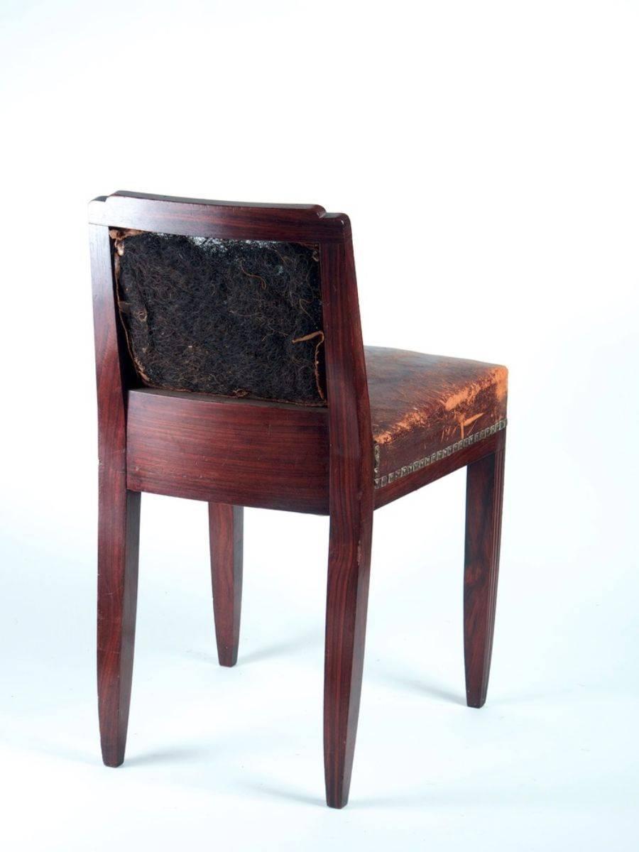 Classic French Art Deco dining chairs with low back. Set of eight, in solid sculpted rosewood, circa 1925. 

Please note that these chairs are unrestored in the photographs.