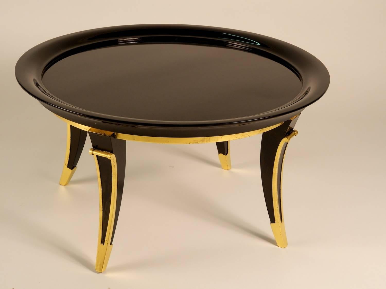 French 1940s Art Deco low cocktail/coffee/side table in black lacquer with gilt trim by Rousseau et Lardin. Restored and refinished.