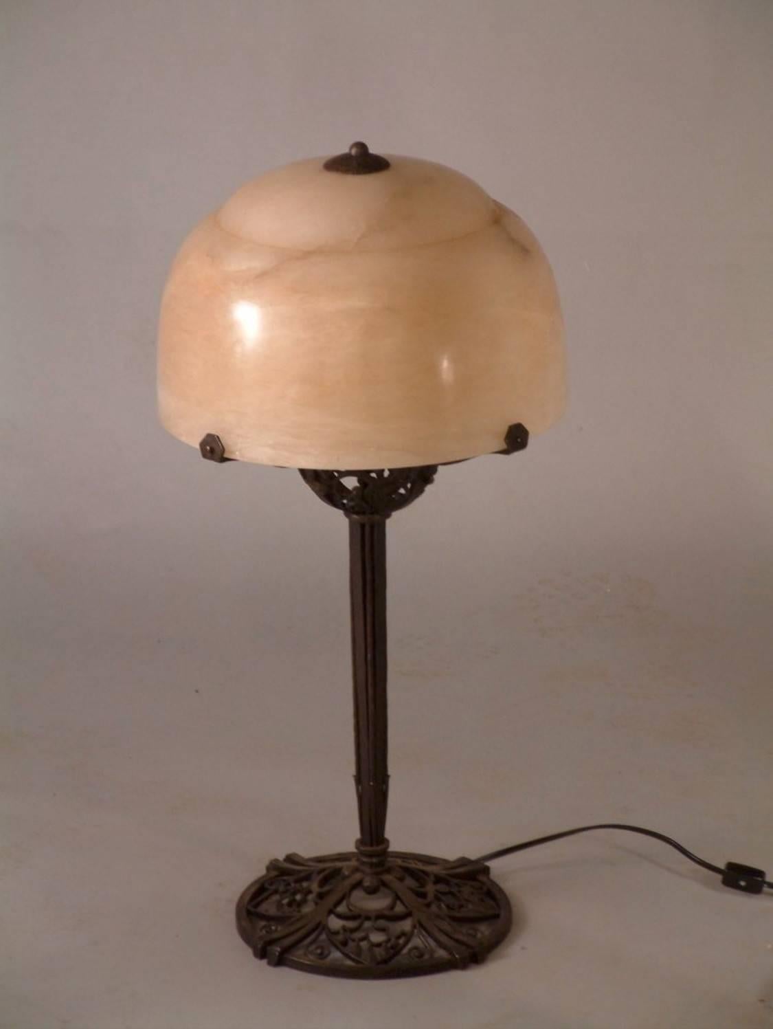 Classic French Art Deco table lamp in forged iron with alabaster shade by Raymond Subes, circa 1923. Measures: About 25