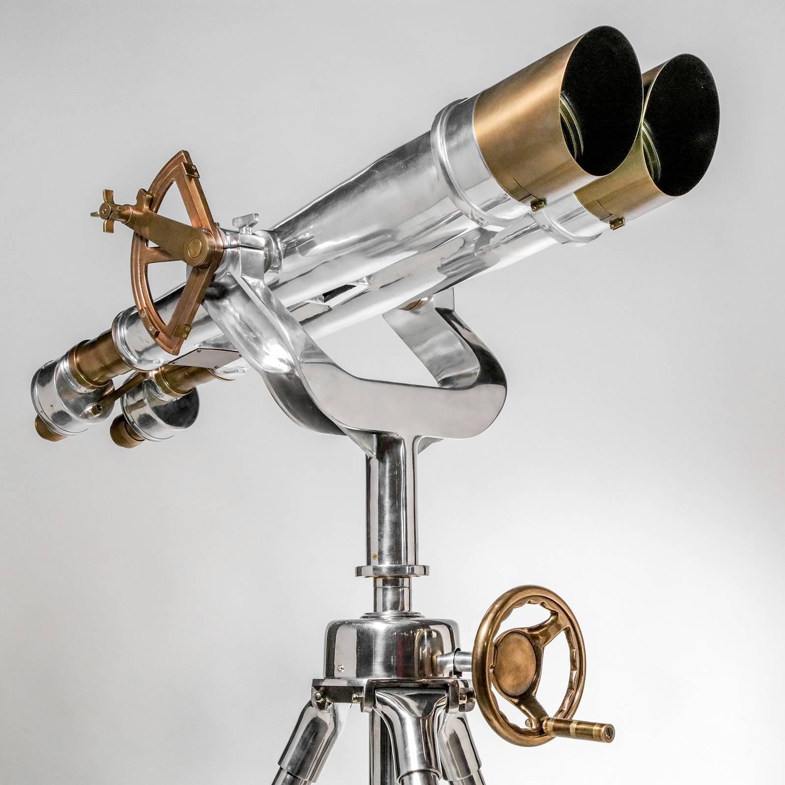 Large pair of field binoculars on adjustable tripod stand. Nickel-plated with brass accents.