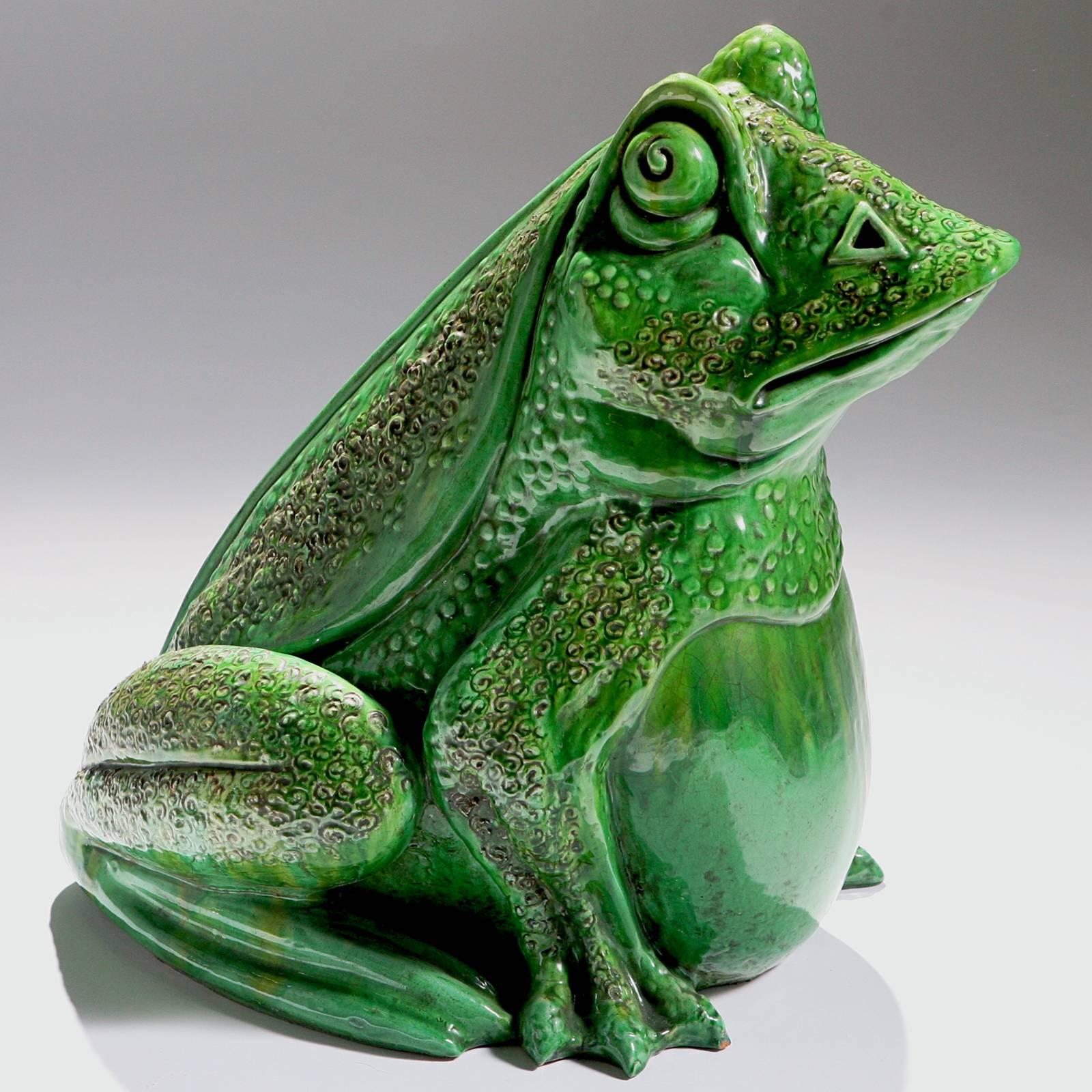 An oversized French garden frog from the early 20th Century.  This two foot high giant has a whimsical expression and a bright green sculpted body.