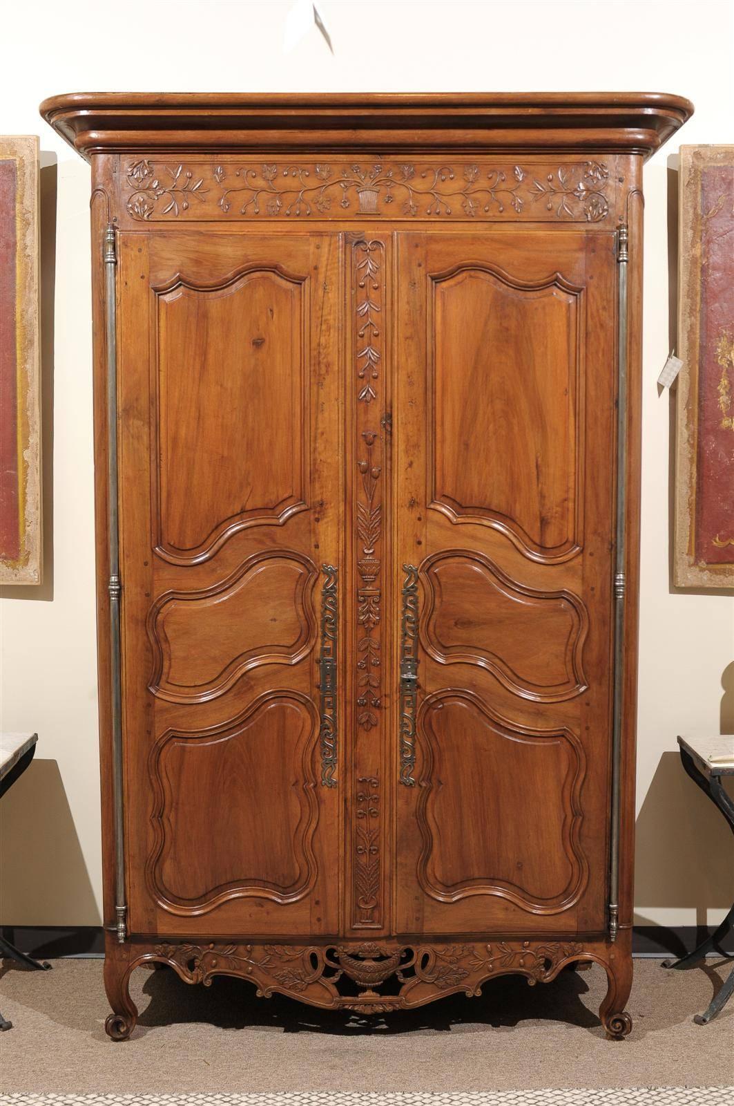 18th Century Walnut Provencal Armoire, circa 1760
This exquisite armoire has been adorned with beautiful carvings of olives, a variety of leaves, and flowers. The most outstanding carving is the reticulated urn on the apron of the armoire. This