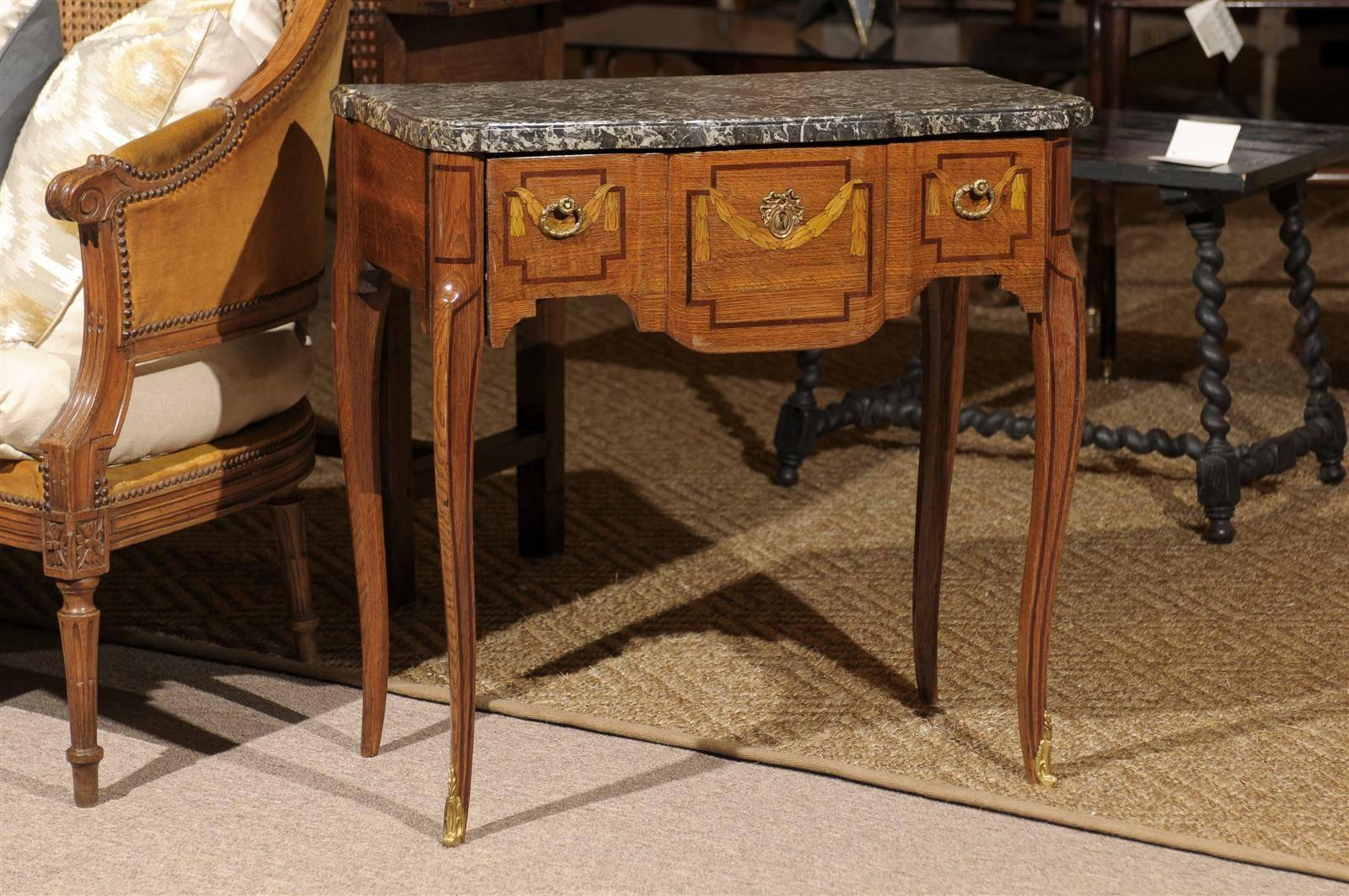 Mid-19th Century Louis XV Inlaid Console with Marble Top, circa 1850
This eyecatching little treasure is perfect for a spot that calls for a small piece with a lot of personality. The inlay is beautiful as are the bronze fittings. The gray and white