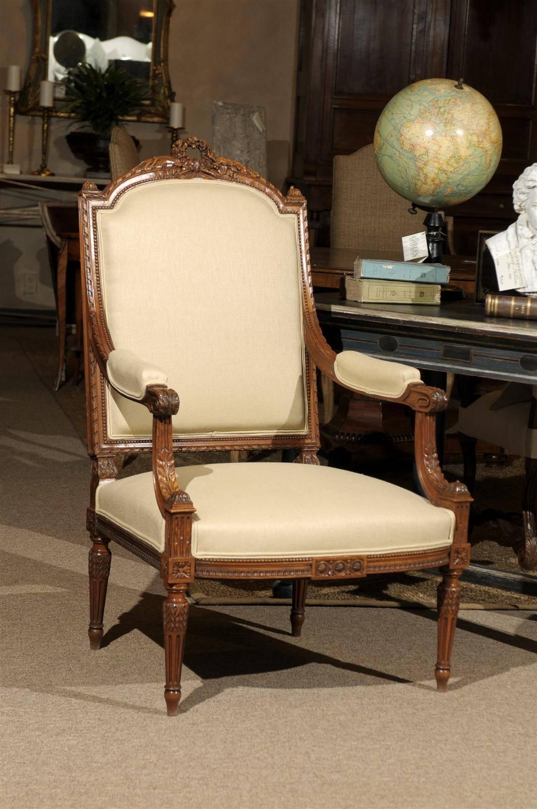 Single Antique Louis XVI Style Armchair in Walnut, circa 1870
Here is a single antique French armchair hand-carved in walnut. The style is classic Louis XVI including straight fluted legs. The carving is elaborate and includes flowers, oak leaves