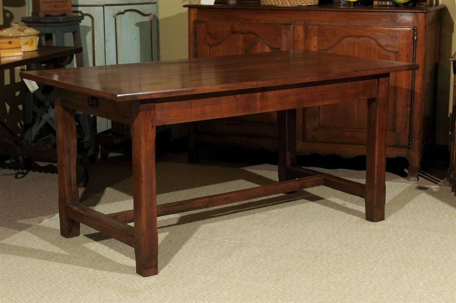 This French farm table is all original. It is solid cherry with a plank top and stretcher base. There are large drawers at each end for great storage. It is a lovely yet simple table that looks great in most spaces and with just about any style of