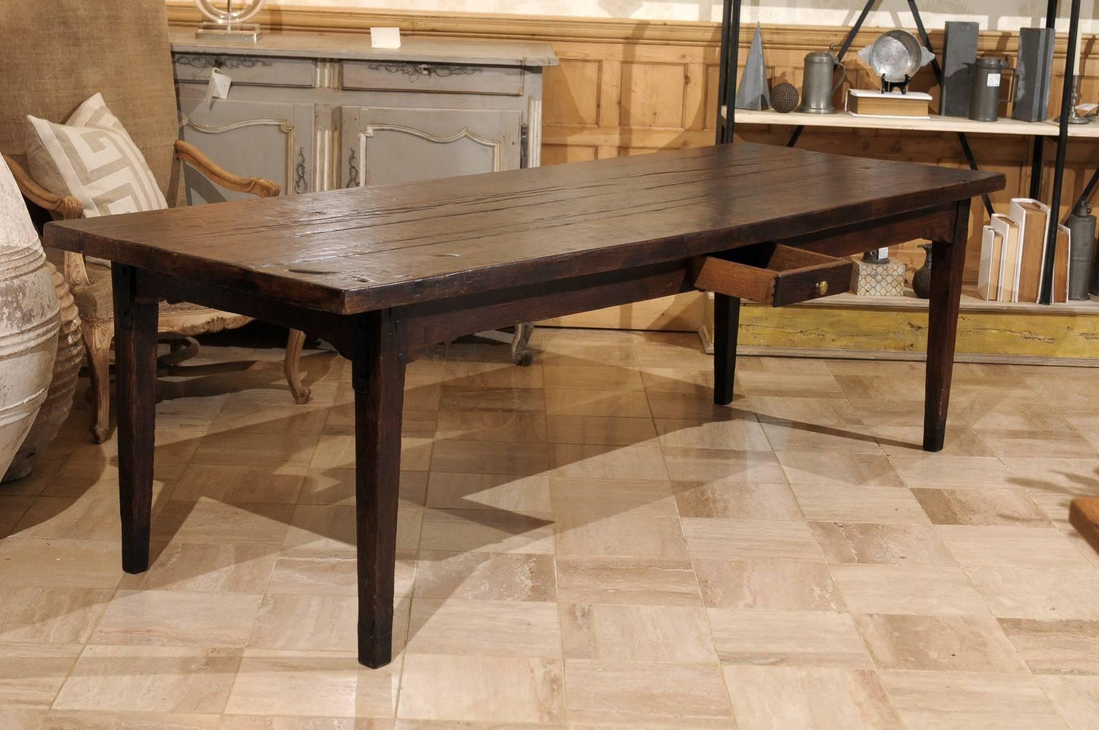 What an interesting French farm table. I like the thickness of the top and the distressing which gives it a more rustic feel. To add to the interest, there are heavy decorative iron pieces on each leg. The apron holds two working drawers and one