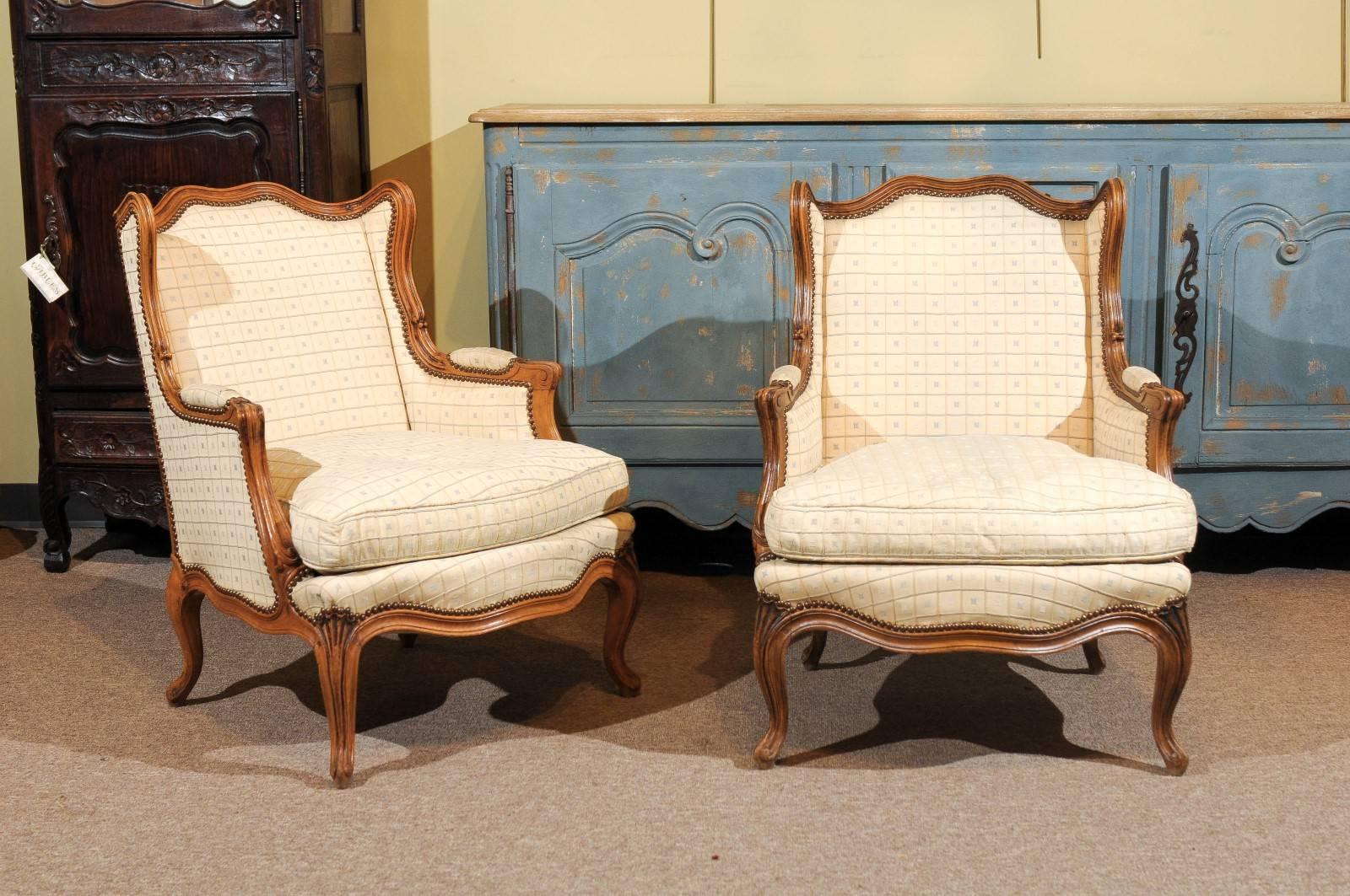 Pair of 19th Century Walnut  Louis XV Style Bergeres, circa 1880
This is a very charming pair of antique beregere chairs in a wonderful walnut frame. The design is very fluid and the size is petite. The chairs are nice and comfortable. They would