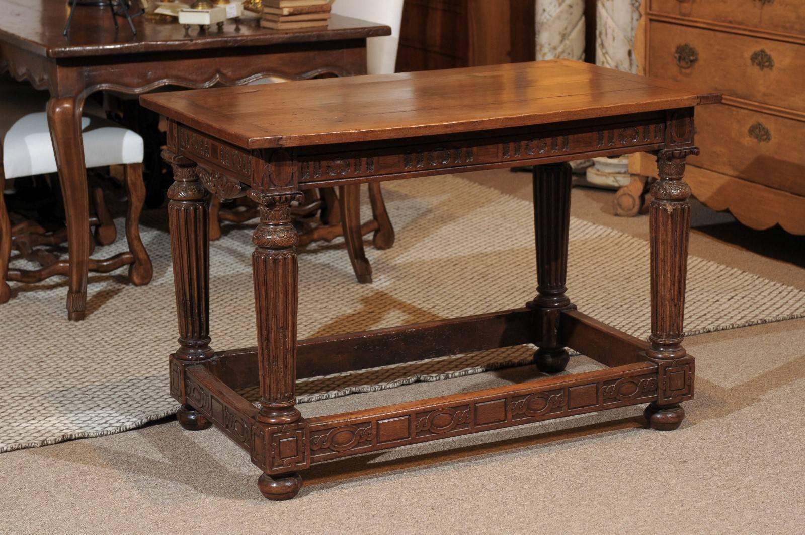 19th Century French Walnut Louis XVI style Side Table, circa 1890.
This handsome table has an intricately carved apron and stretcher. The fluted legs and bun feet add to the weight of the design. The old walnut has come alive with the beautiful