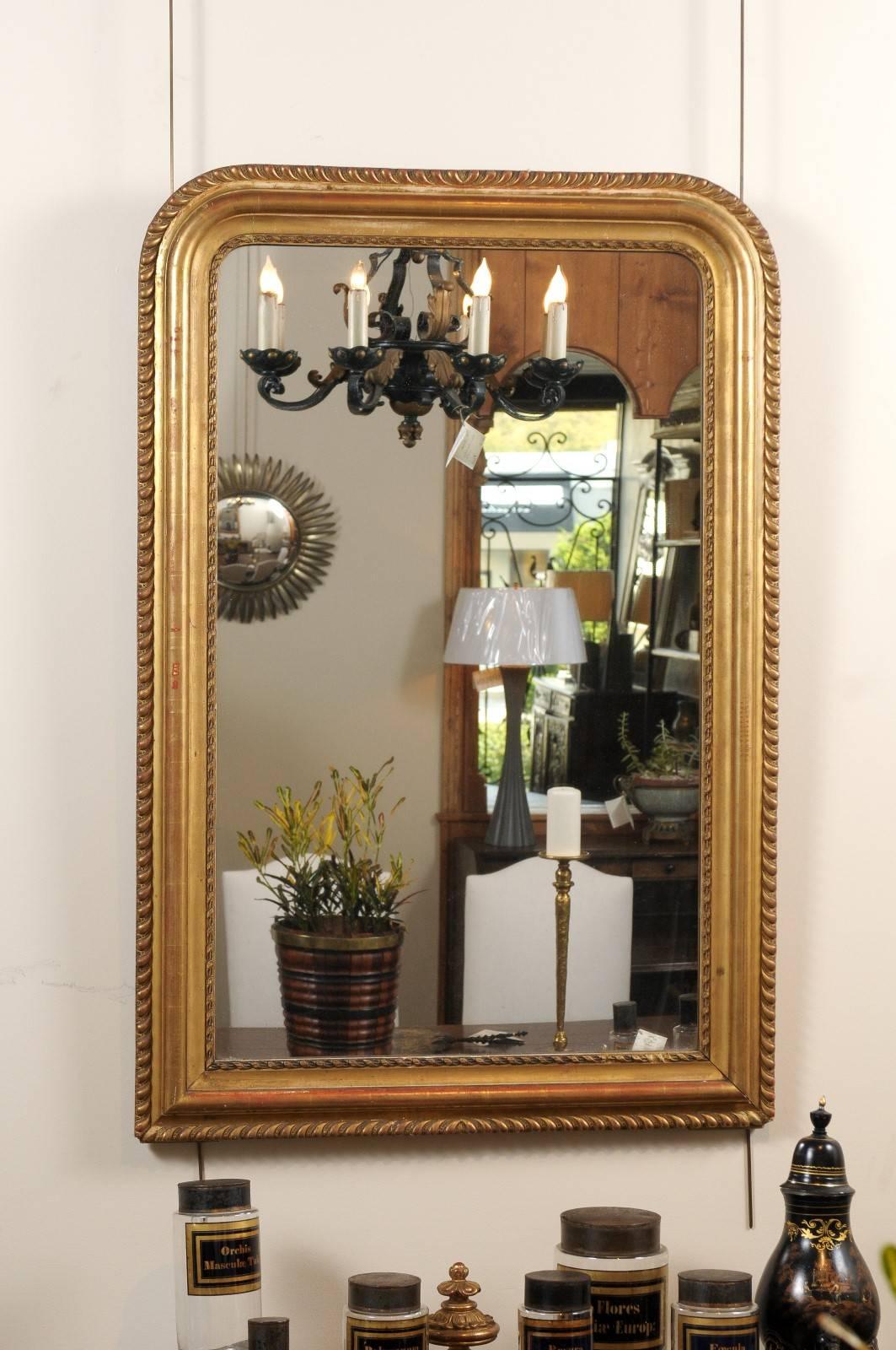 This 19th century Louis Philippe gold gilt mirror is an example of the classic style from the Louis Philippe period. The gilt has a nice patina with some red showing through.
