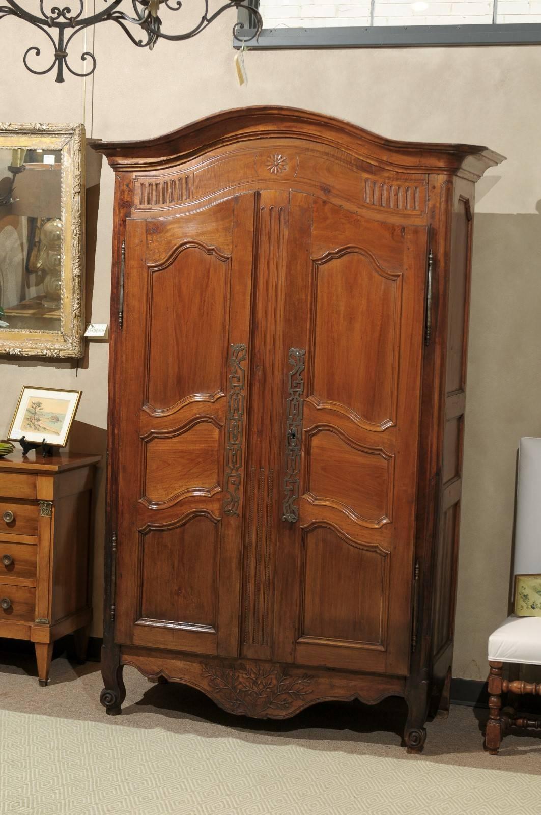 Louis XVth Style  Walnut Armoire with Domed Top, circa 1840
With three shelves, this little armoire provides plenty of storage or if it needs to house a television, one shelf can be removed easily. It has just enough carving with the olive branch on