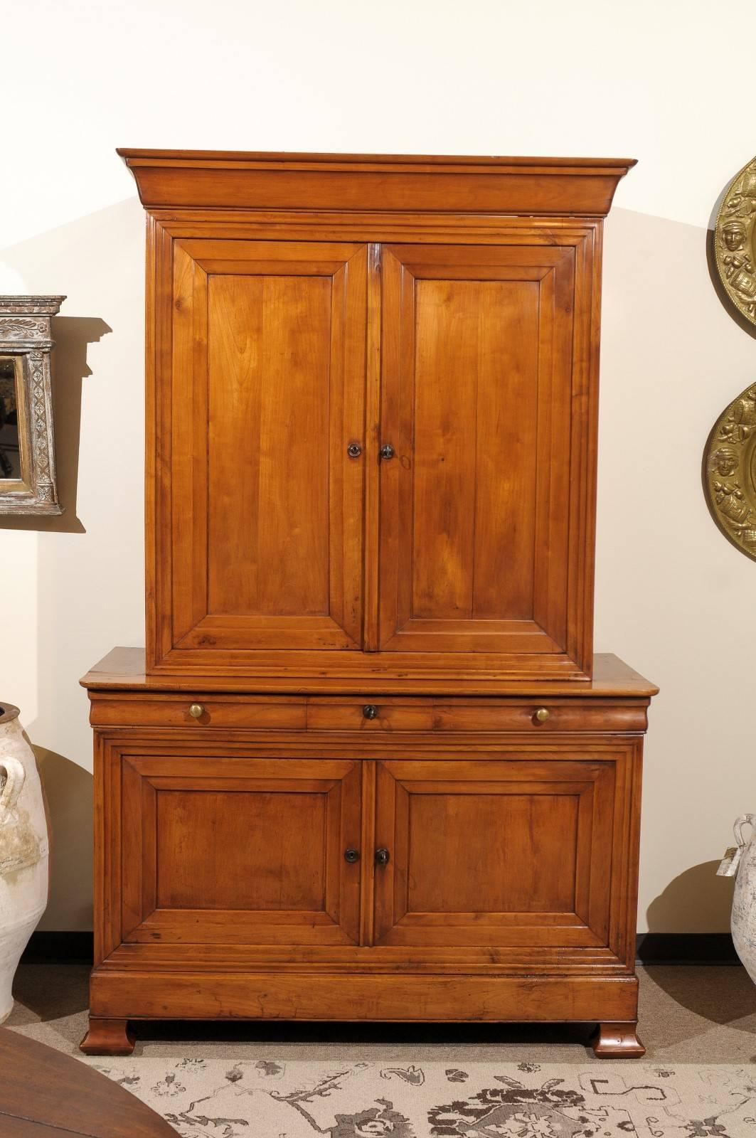 Period Louis Philippe Buffet Deux Corps in cherry, circa 1830.
The nearly 200 year old cherry of this buffet deux corps has a magnificent patina and a wonderful grain pattern. The lines are simple which seems to work well with current design